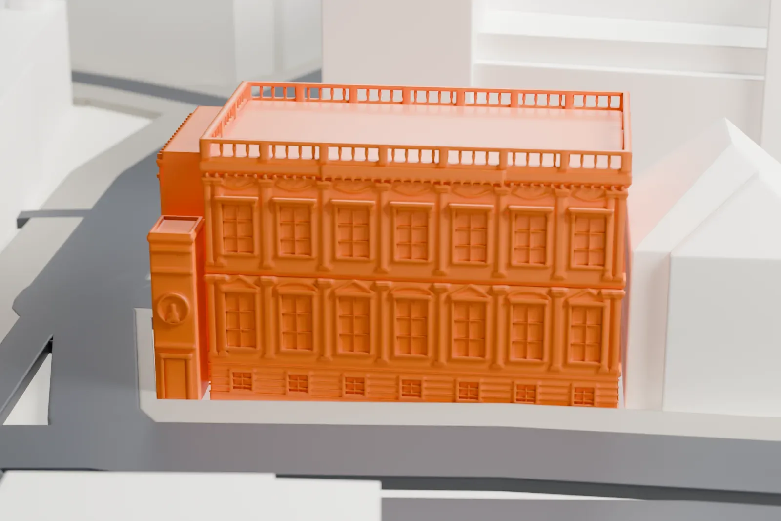 A white 3D print of the Banqueting House, a long, low hall, standing among the buildings along a city street.