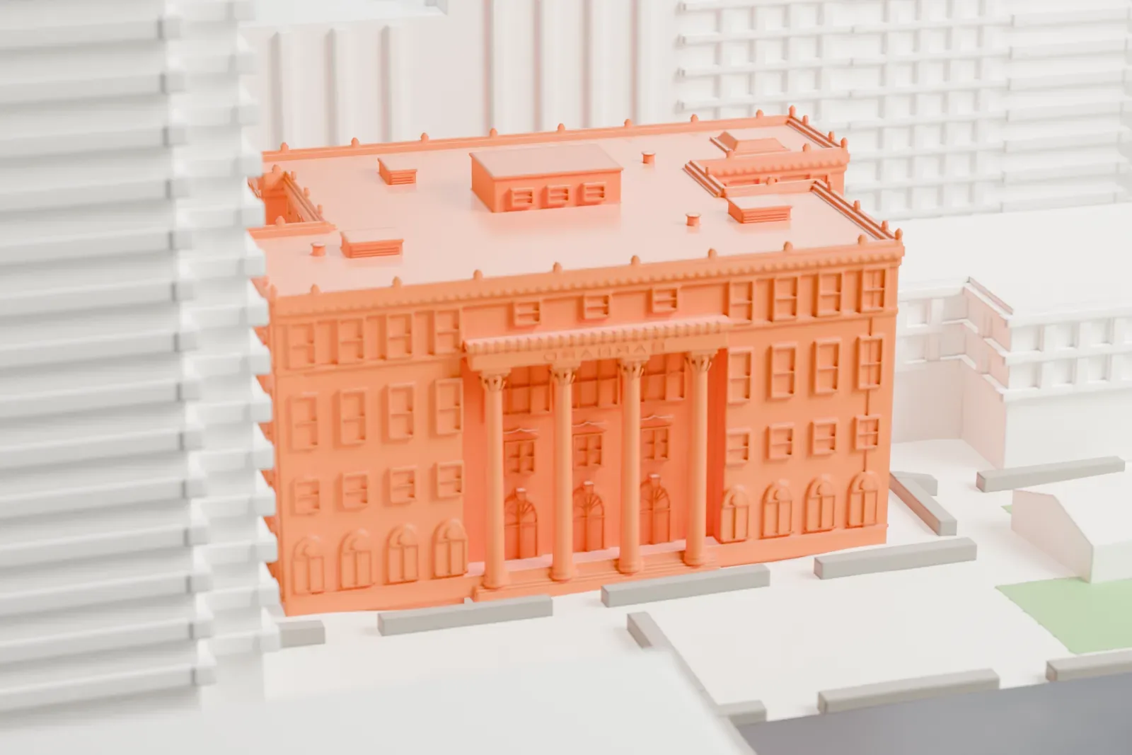 A white 3D print of Barnard Hall, a four-story building with a columned portico on its front, surrounded by taller buildings and streets.