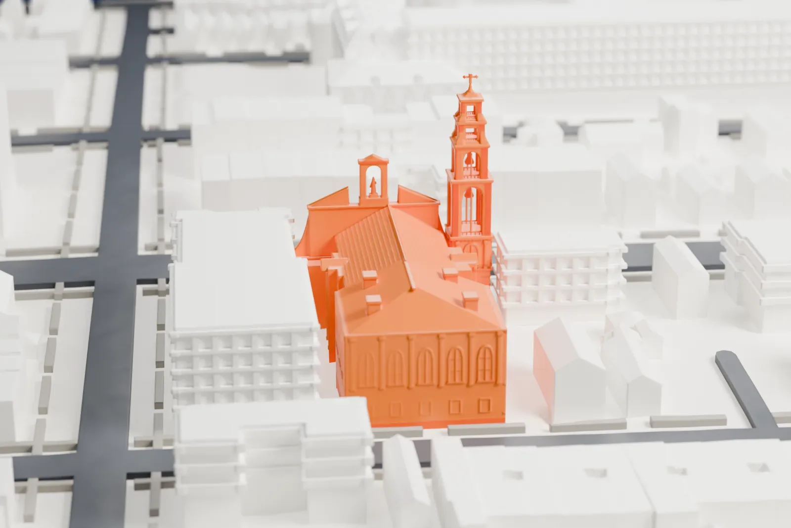 A white 3D print of the Basilica of Regina Pacis, a church with a tall bell tower and a pitched roof, among low buildings and narrow streets.