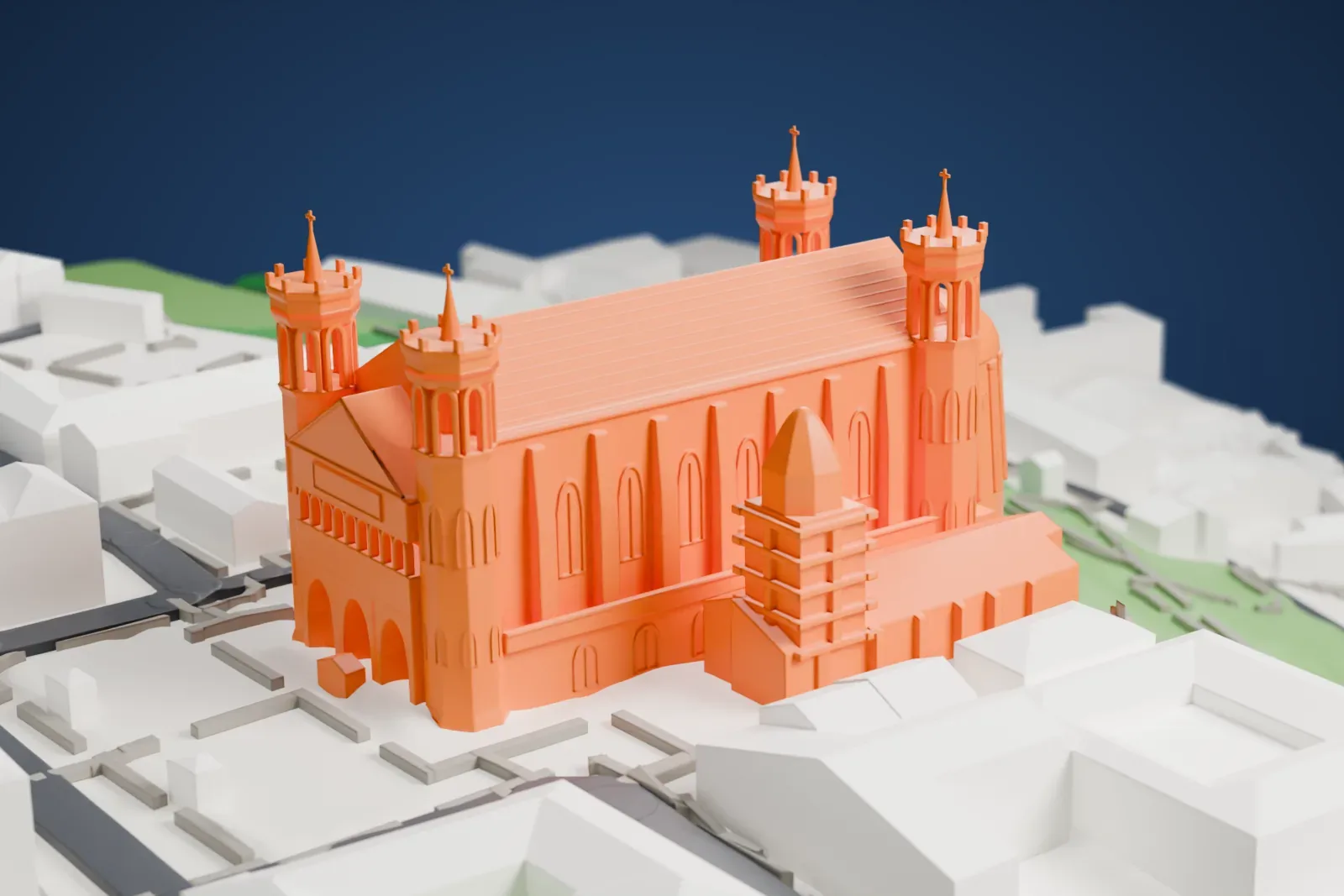 A white 3D print of the Basilique de Fourvière, a long church with four corner towers topped by slim spires, on a hillside with grassy slopes and buildings around it.
