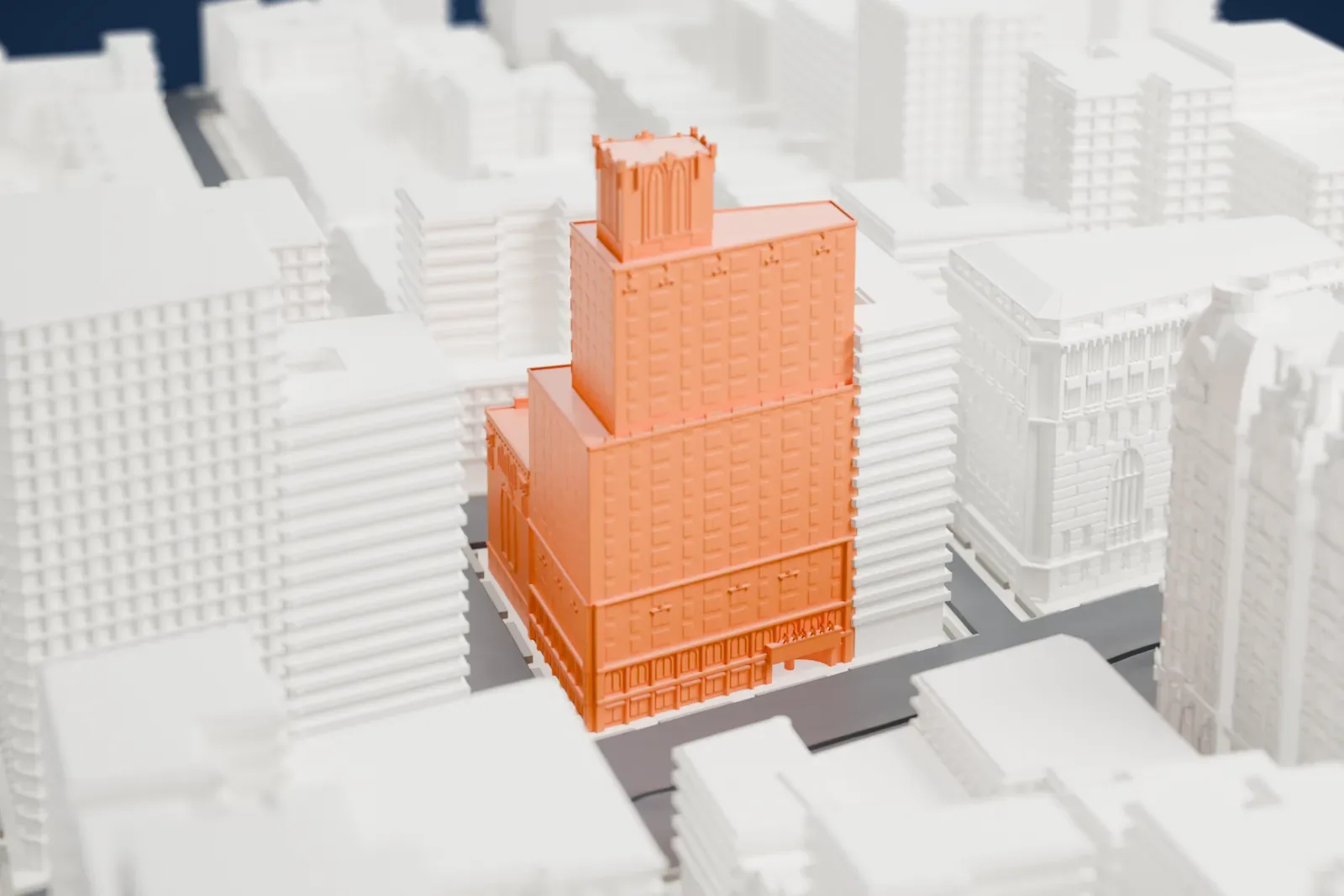 A white 3D print of the Beacon Theatre, a stepped tower with a small arched crown, among mid-rise buildings and Upper West Side streets.