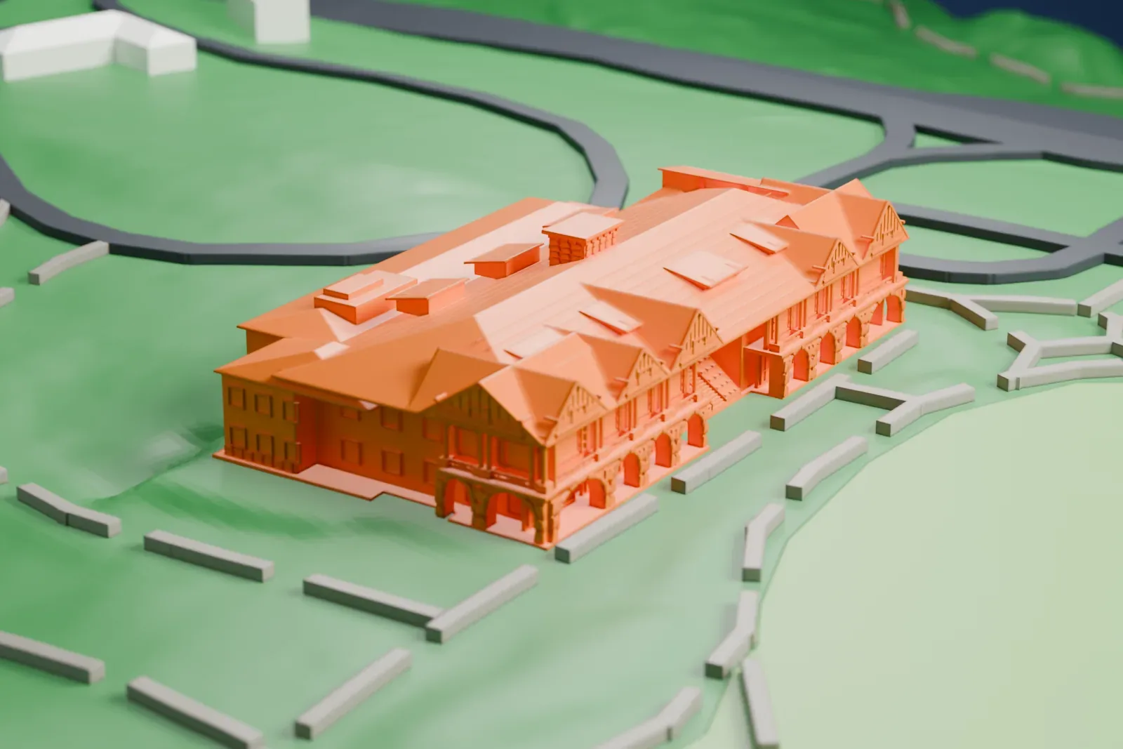 A white 3D print of the Bear Mountain Inn, a long lodge with many small gables, set on green parkland with paths and curving roads.