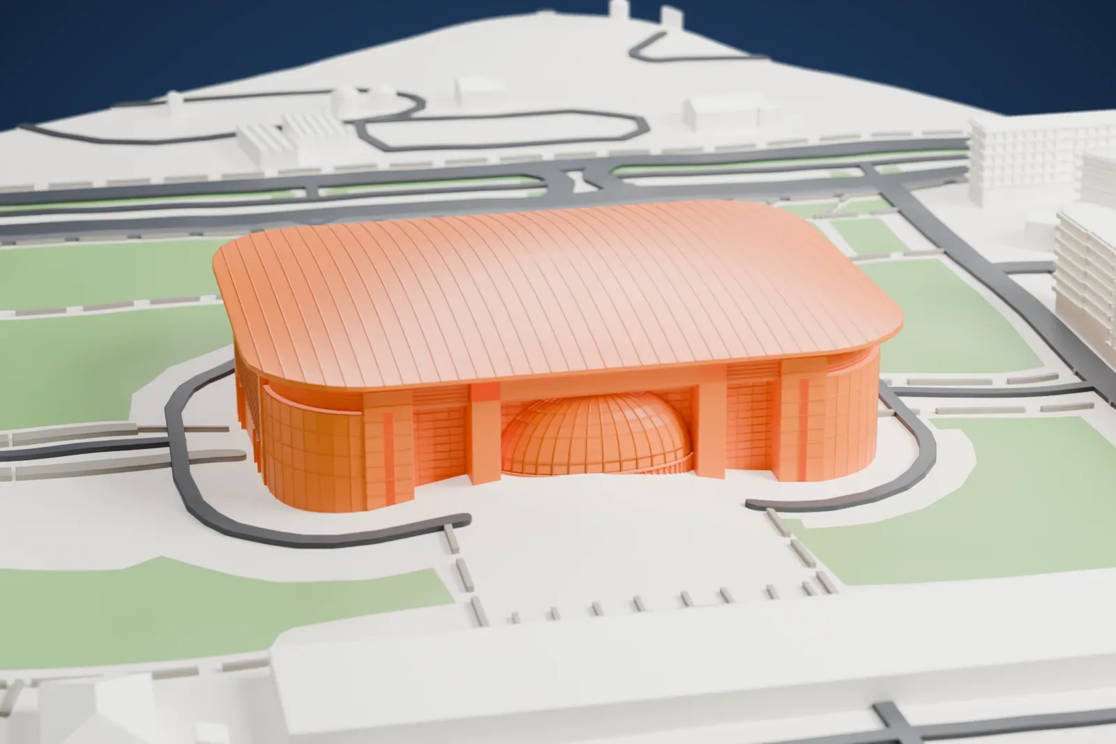 A white 3D print of the Belgrade Arena, a large block with rounded corners and a long ribbed curved roof, with a small ribbed dome at the entrance, set among grass, roads and mid-rise buildings.