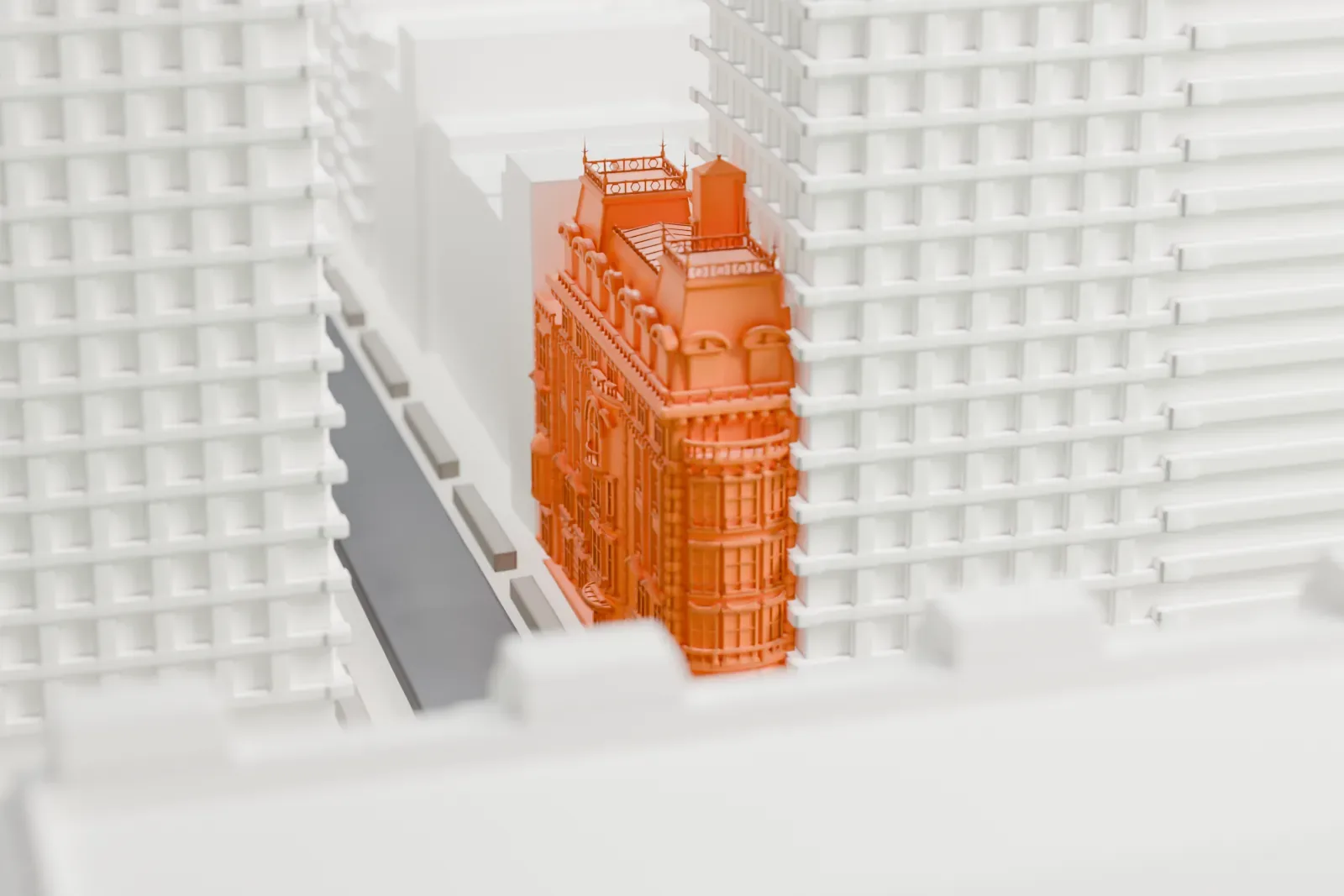 A white 3D print of the Benjamin N. Duke House, a tall, narrow mansion with a mansard roof, set among much taller buildings.