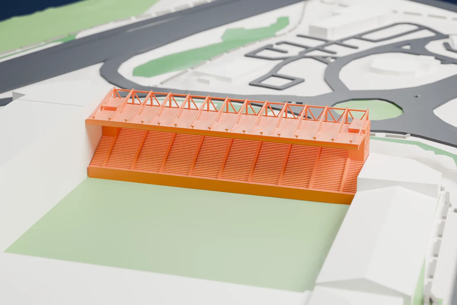 A white 3D print of the East Stand at Bet365 Stadium, a long single-tier stand with a mono-pitch roof and white mast-and-tie trusses above it, among surrounding streets and buildings.