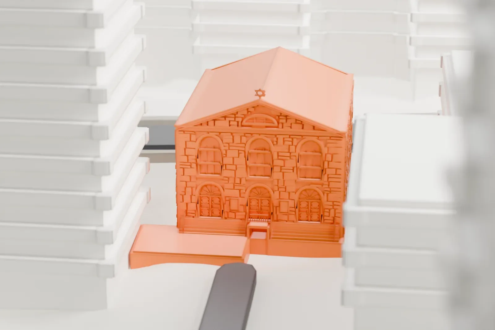 A white 3D print of the Bialystoker Synagogue, a stone building with a plain gabled roof and arched windows, squeezed between much taller buildings.