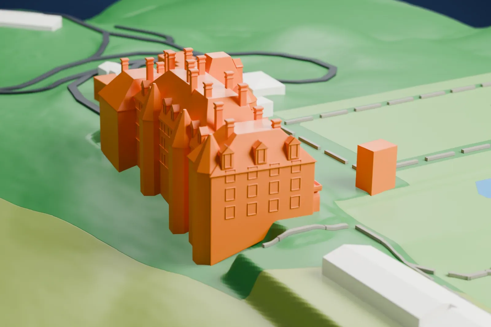 A white 3D print of Biltmore House with its steep roofs, dormers, chimneys and turrets, set among green lawns, small ponds and winding drives.