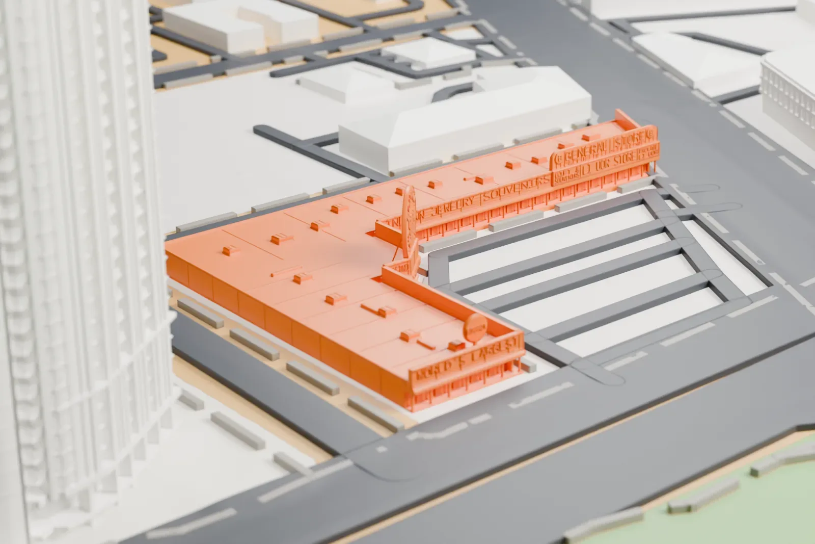 A white 3D print of the Bonanza Gift Shop, a long L-shaped low building with a round sign at its corner, beside wide roads and parking lots.