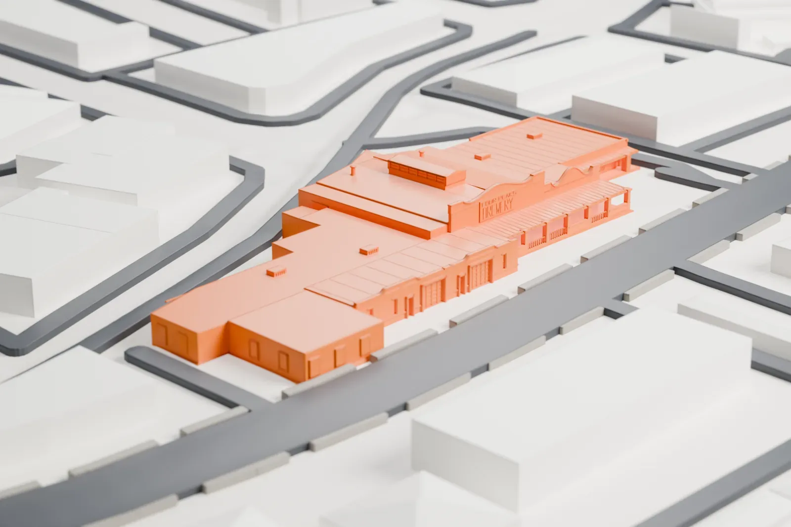 A white 3D print of the Borden Milk Company Creamery, a long, low group of connected buildings with ridged roofs, beside curving streets and low buildings in Tempe.