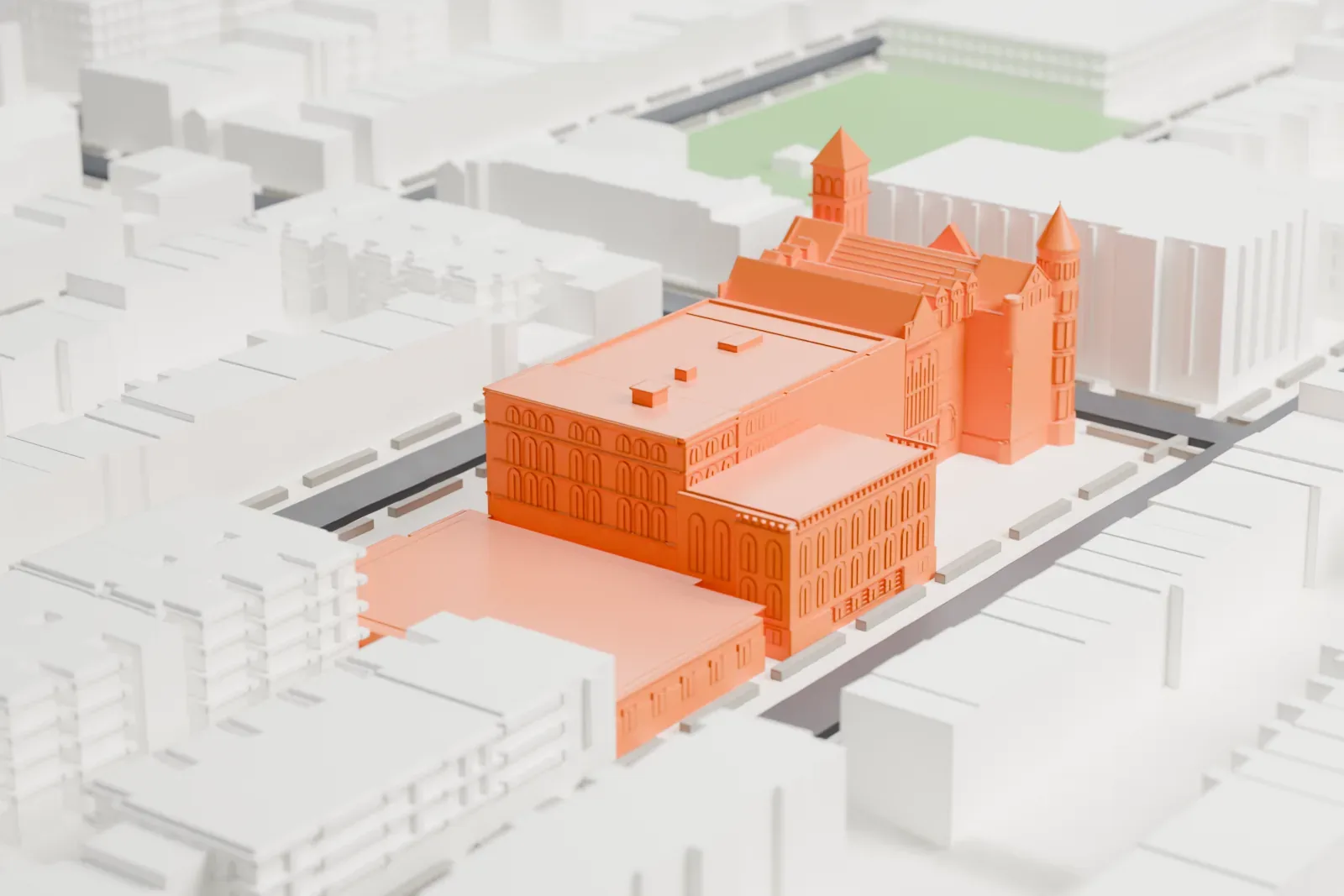 A white 3D print of Boys High School in Brooklyn, a long building with round corner towers and gables, surrounded by blocks of low buildings and streets.