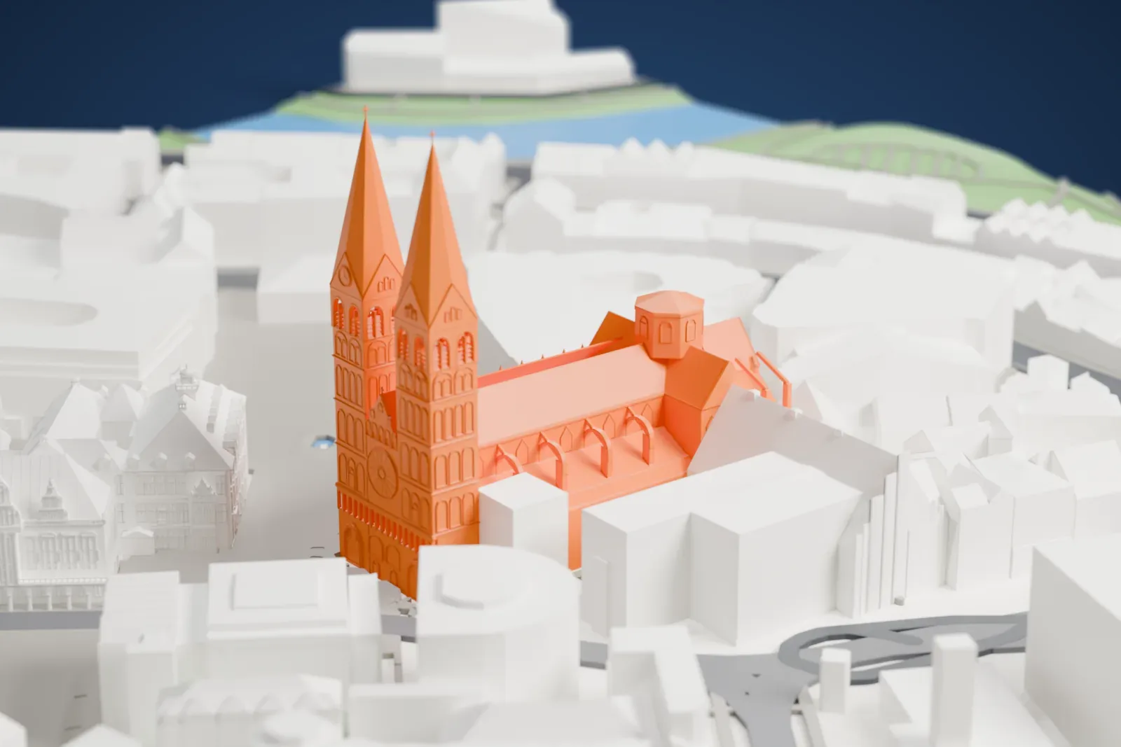 A white 3D print of Bremen Cathedral, with two west towers, standing on the market square among surrounding city buildings.