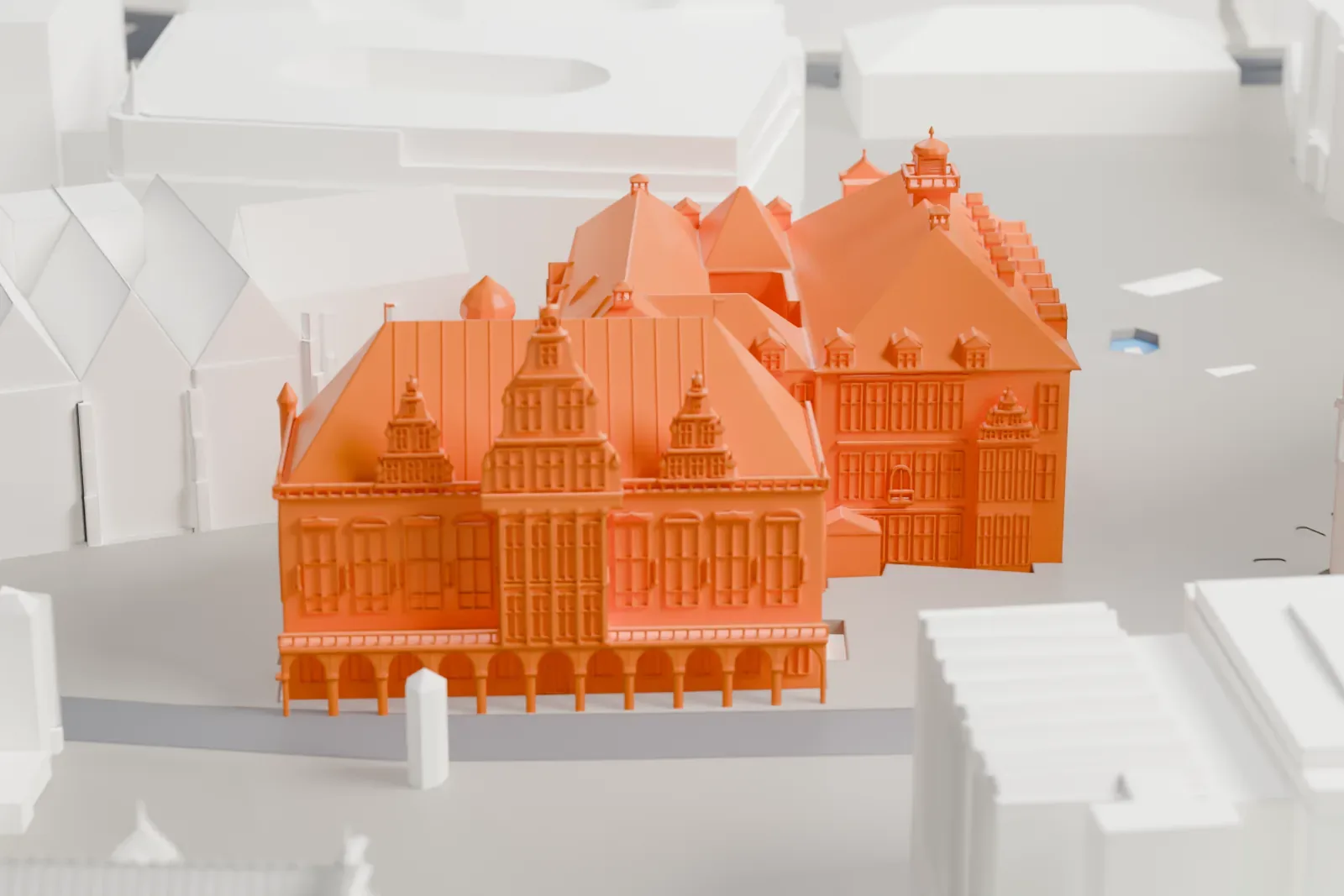 A white 3D print of the Bremen Town Hall on its market square, with the surrounding streets and buildings of the historic center.