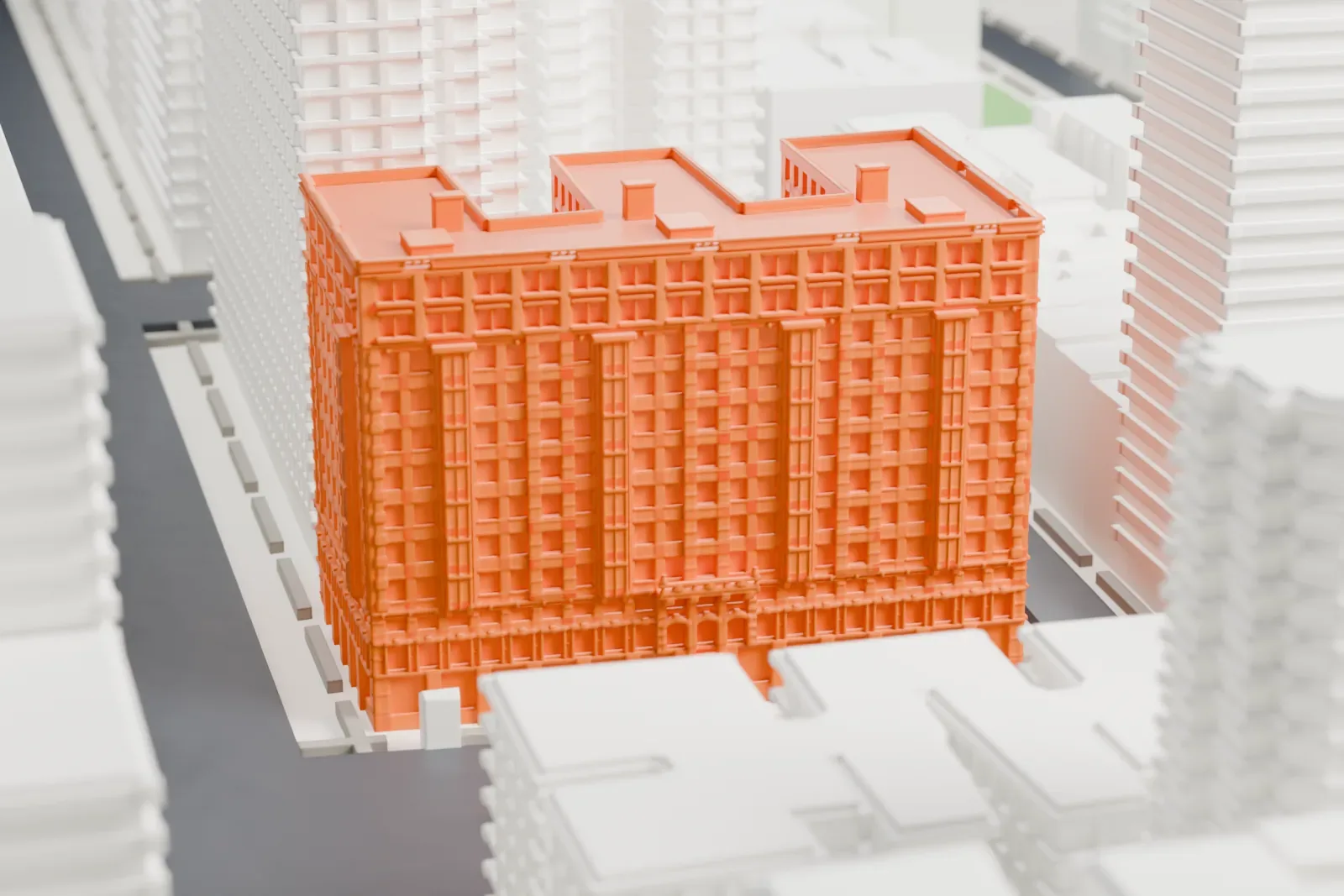 A white 3D print of Bretton Hall, a tall residential building with a stepped roofline and rows of windows, standing among taller buildings and streets.