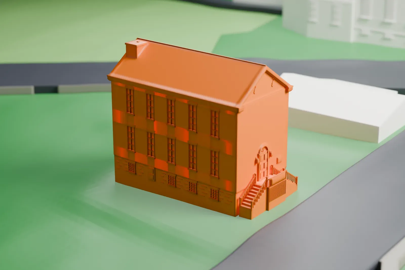 A white 3D print of the Brick Academy, a plain gabled building with rows of tall windows and entrance steps, on a grassy lot beside a curving road.