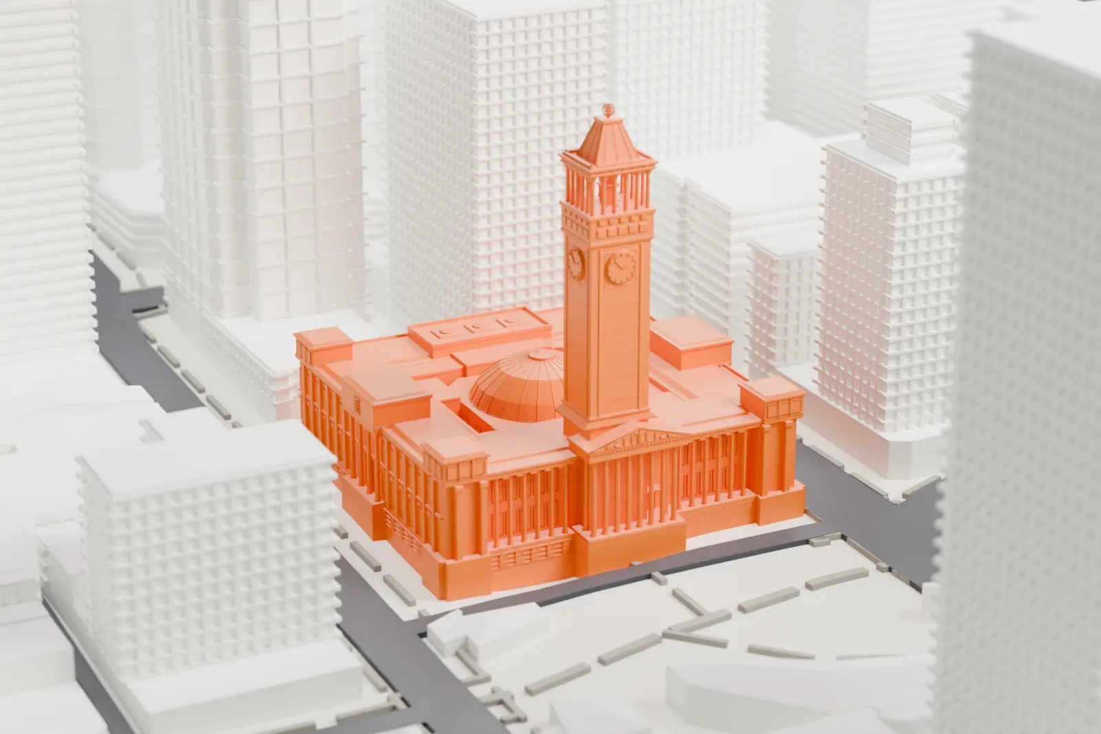 A white 3D print of the Brisbane City Hall building, with a pointed clock tower, low dome and rows of columns surrounded by streets and taller buildings.