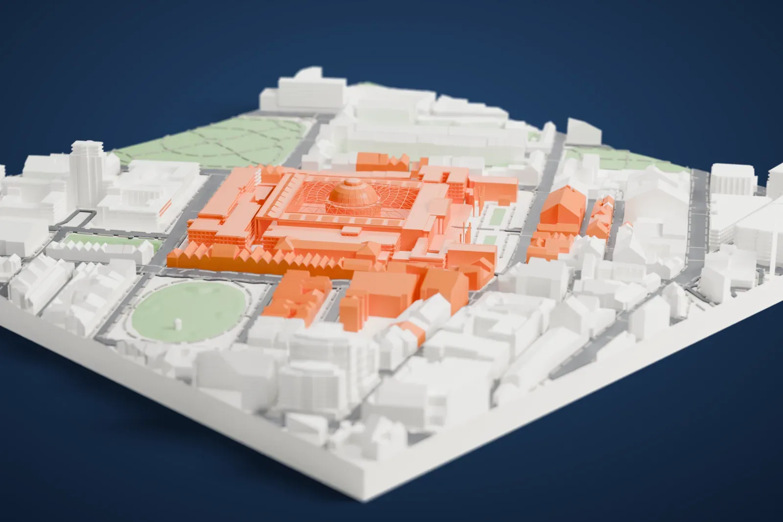 A white 3D print of the British Museum, a large square building with a columned front and a domed round room inside a latticed courtyard, among London streets and green squares.