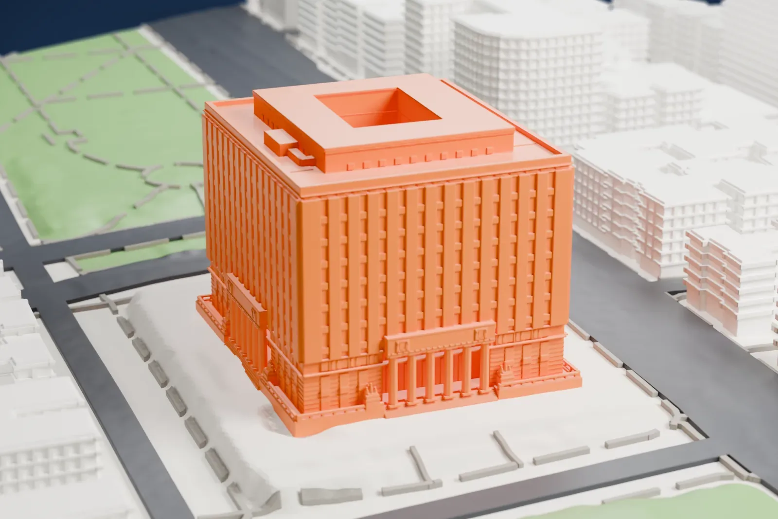 A white 3D print of the Bronx County Courthouse, a large boxy building with a columned entrance and a sunken court in its roof, beside a park and surrounded by city streets and lower buildings.
