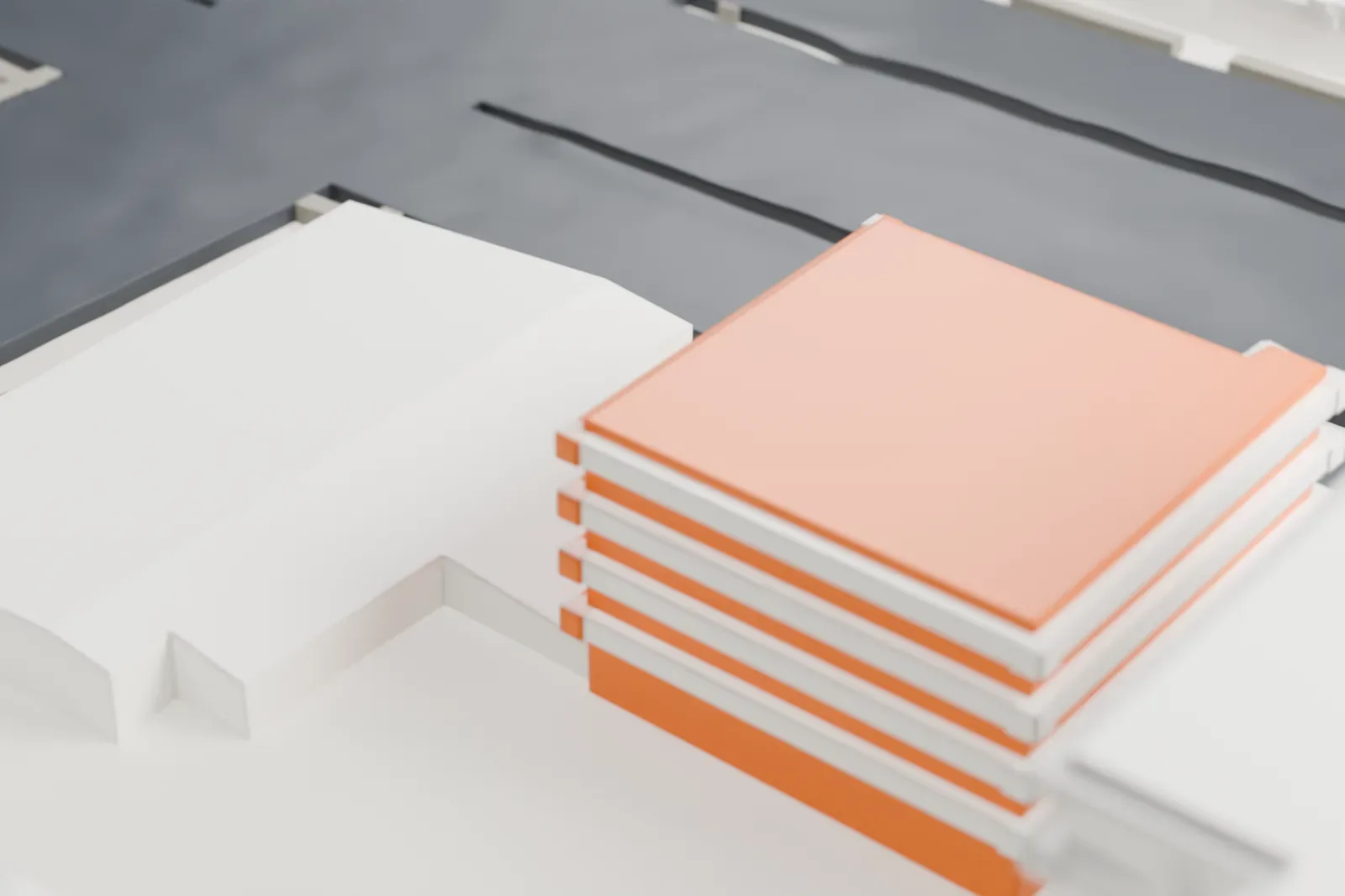 A white 3D print of the Bronx Museum of the Arts, a low building of stacked boxy volumes on a street corner, surrounded by taller buildings and roads.