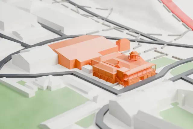 A white 3D print of the Brooklands Automobile Racing Club Clubhouse model in London, with the streets around it.