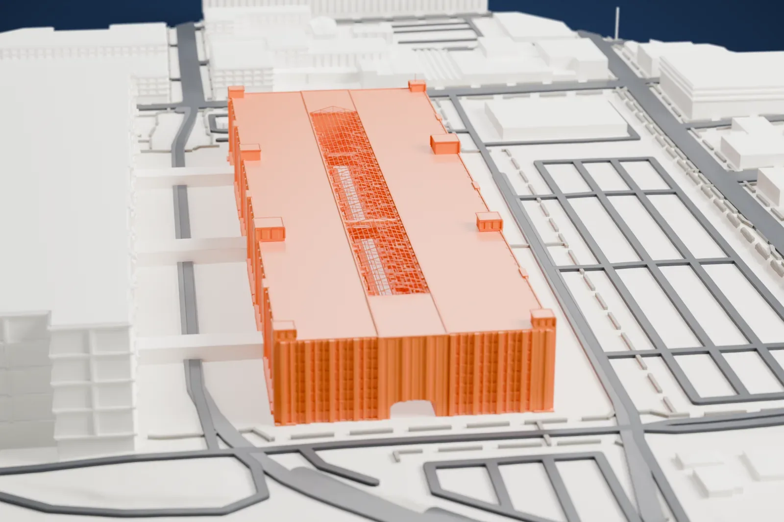 A white 3D print of the Brooklyn Army Terminal, a very long multi-story warehouse beside a huge neighboring warehouse, with streets, rail lines and water nearby.