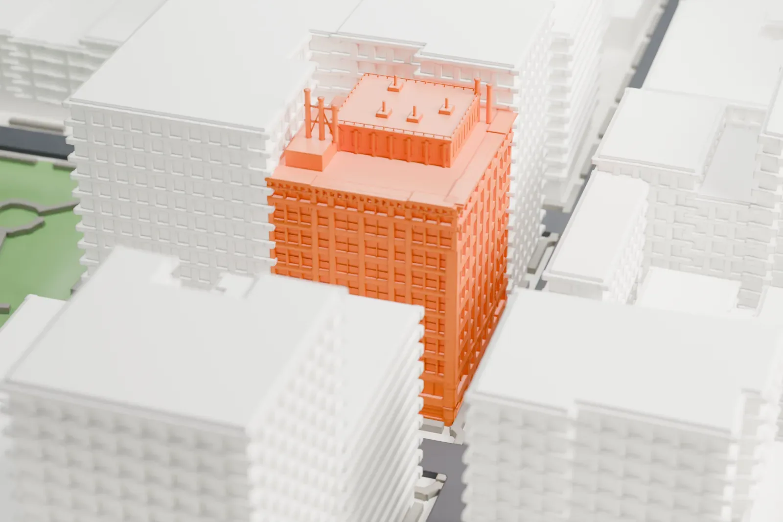A white 3D print of the Brown Building, a detailed block with small roof pipes, surrounded by taller plain buildings.