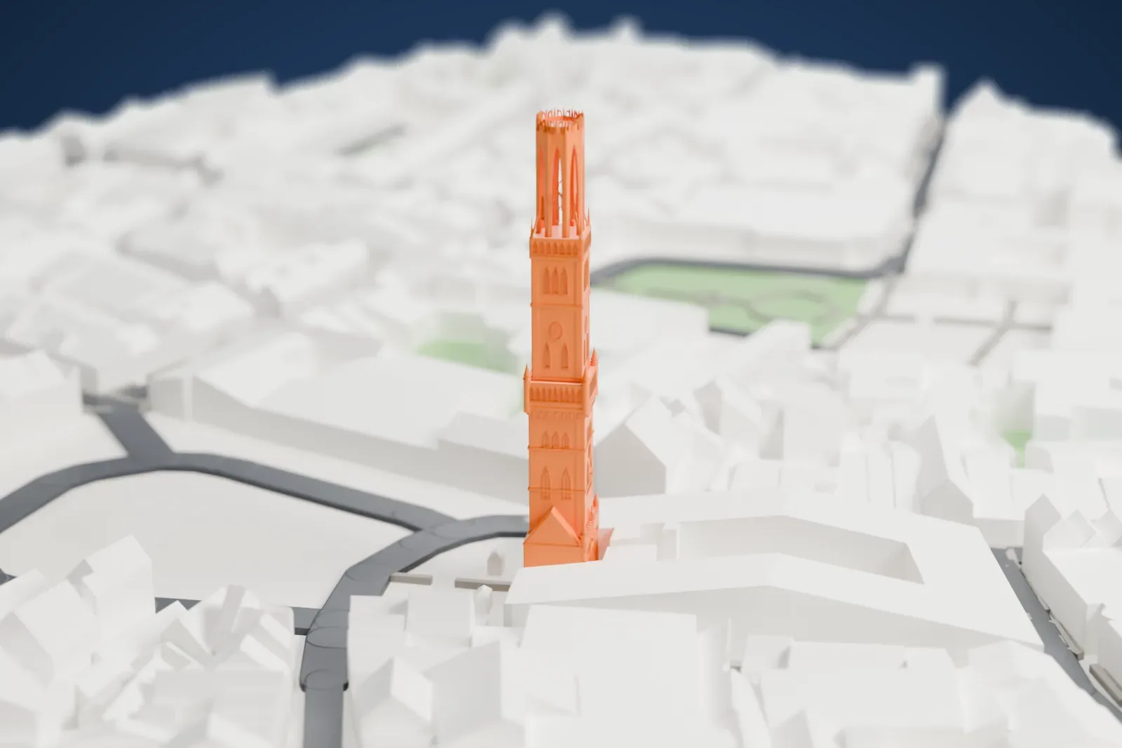 A white 3D print of the Belfry of Bruges, a tall bell tower with a pinnacled top, rising among dense low buildings and curving streets with a little water and green nearby.