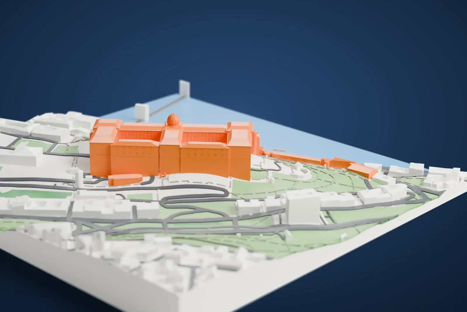A white 3D print of Buda Castle, a long palace with a central dome and courtyards on a hilltop, with roads, buildings and water around it.