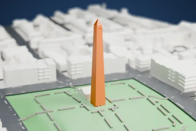 A white 3D print of the Bunker Hill Monument, a tall tapering obelisk with a pointed top standing in a green park, with streets and buildings around it.