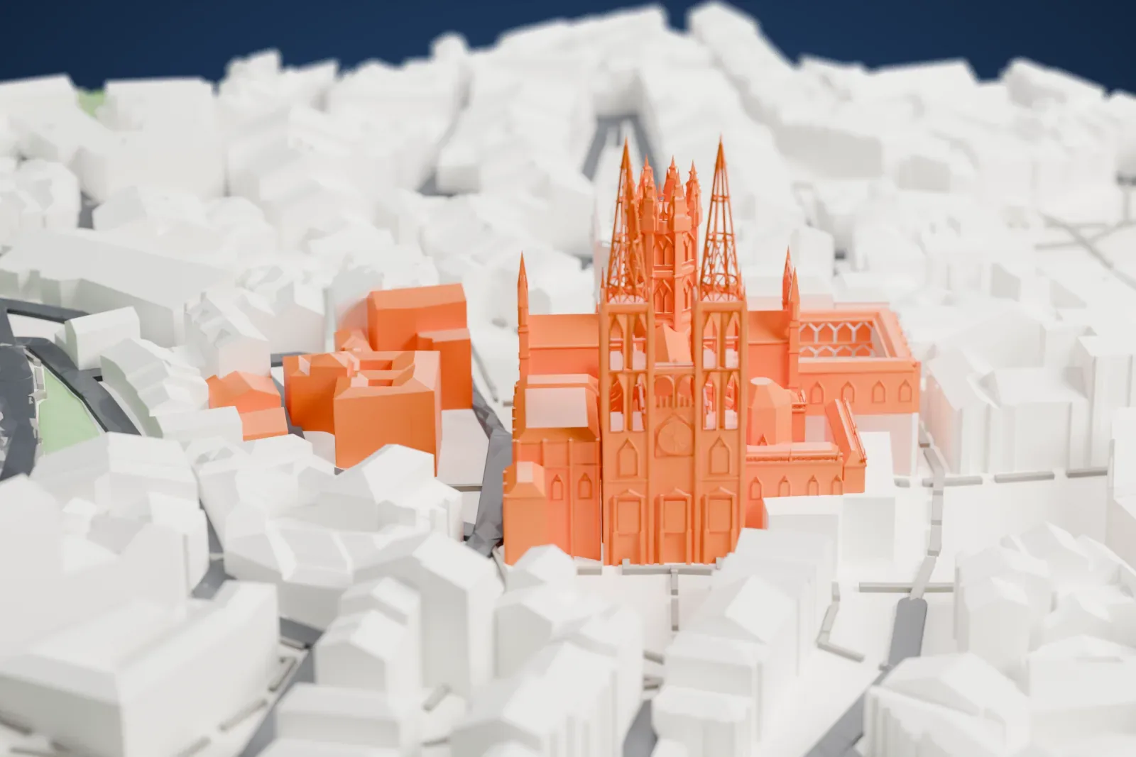 A white 3D print of Burgos Cathedral, with two openwork spires, a pinnacled octagonal lantern and a cloister, standing among crowded old-town buildings.