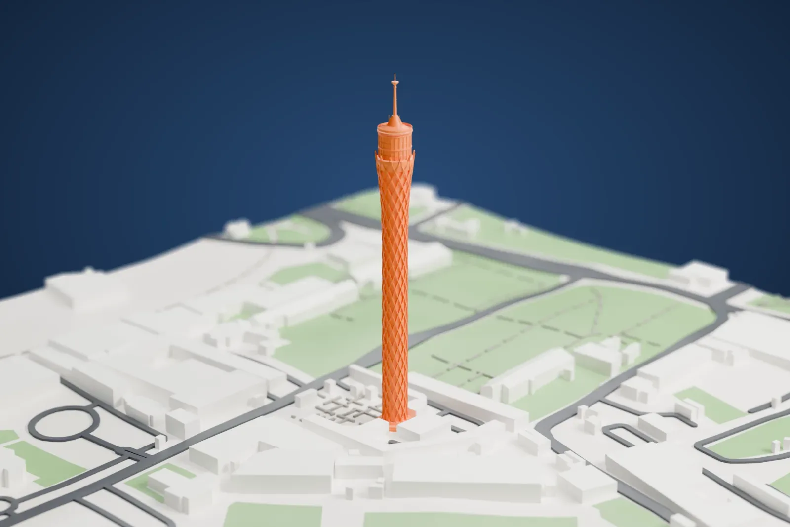 A white 3D print of the Cairo Tower, a slender lattice tower with a round deck and a thin spire, standing among buildings, roads and green parks.