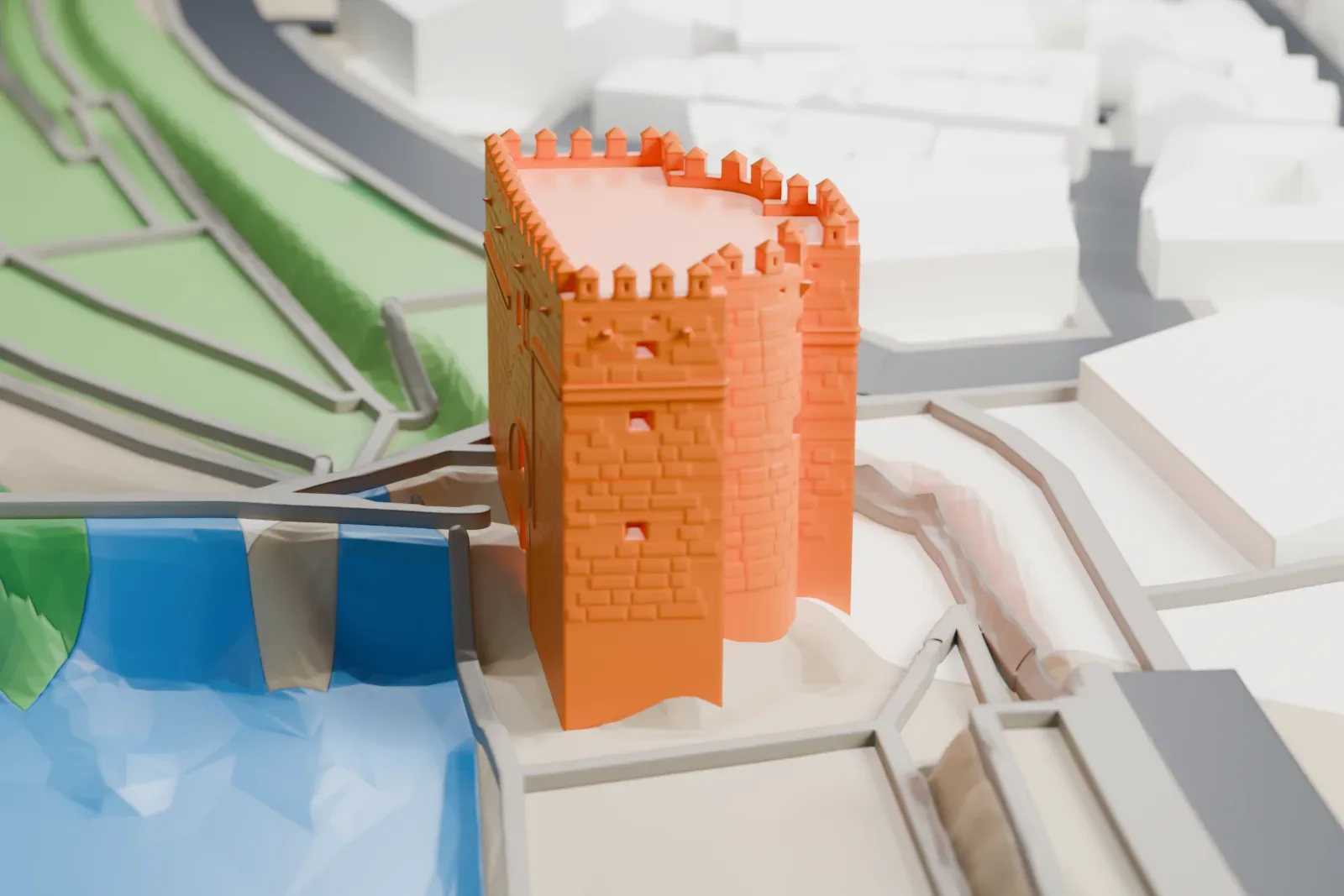 A white 3D print of the Calahorra Tower, a battlemented gate tower with a rounded central bay, beside the river and surrounded by streets.