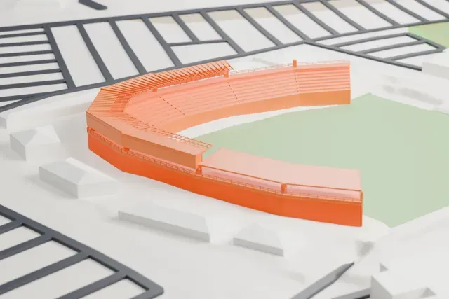 A white 3D print of Camelback Ranch, a curved grandstand around a green field, with roads and low buildings nearby.