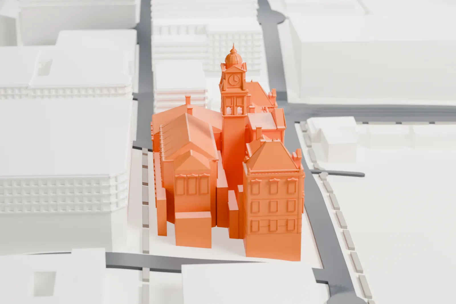 A white 3D print of Cape Town City Hall, with its central clock tower and steep roofs, among surrounding city buildings and streets.