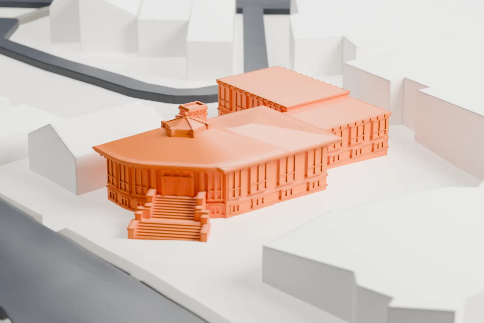 A white 3D print of the Carnegie Library in Montclair, a low building with a curved front, entrance steps and a small cupola, set among nearby buildings and streets.