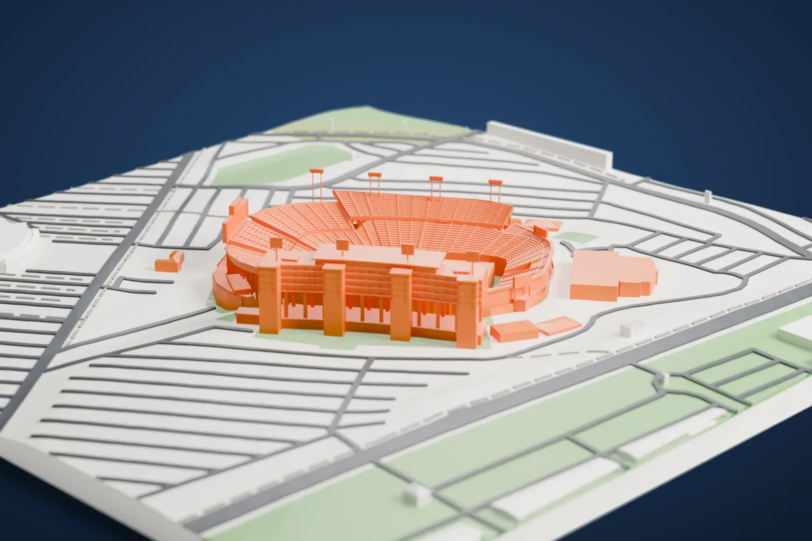 A white 3D print of Carter–Finley Stadium, a bowl of curved seating with a tall tiered tower on one side, surrounded by roads and open ground.