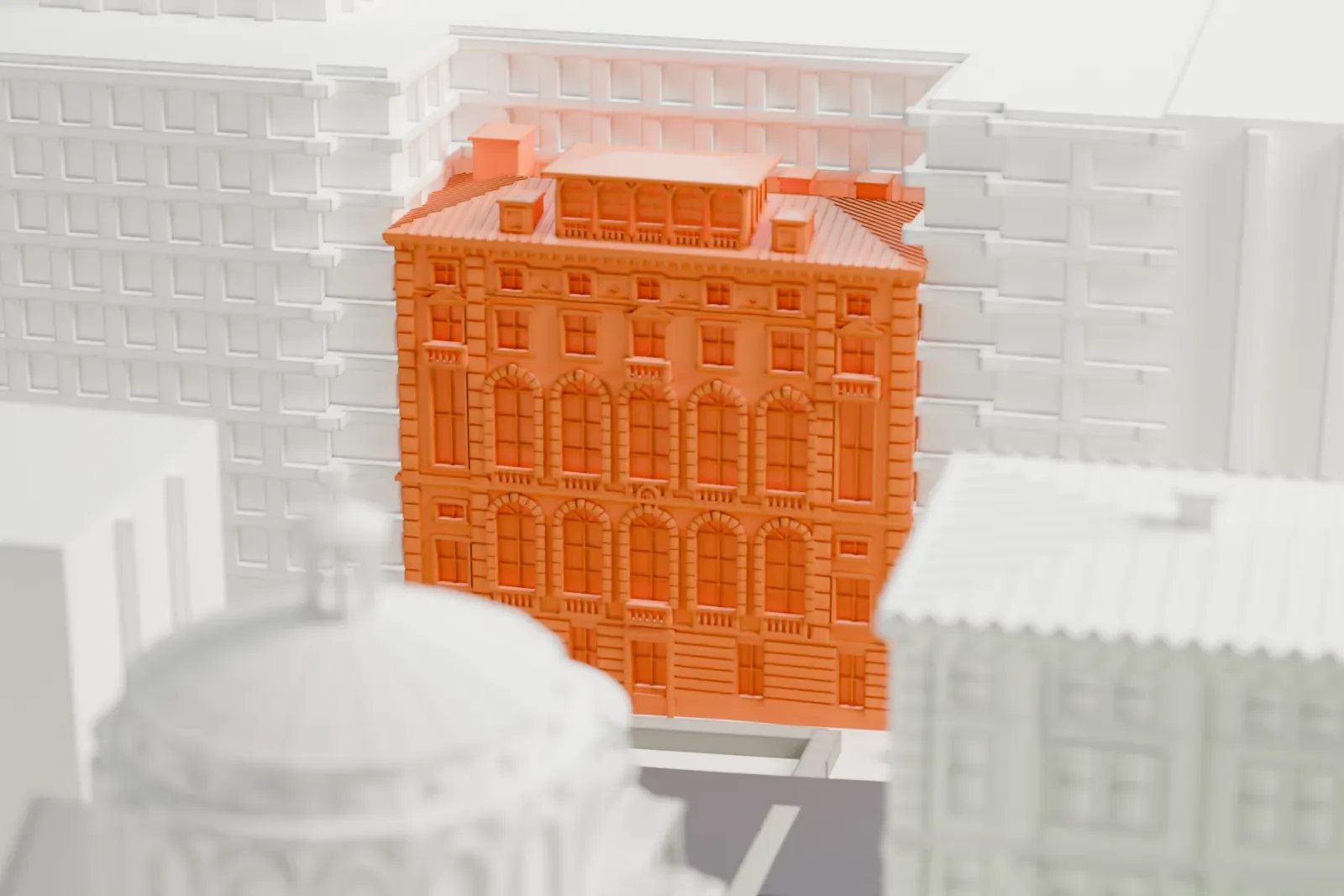 A white 3D print of Casa Italiana, a narrow building with arched windows and a hipped roof, wedged between much larger blocks.