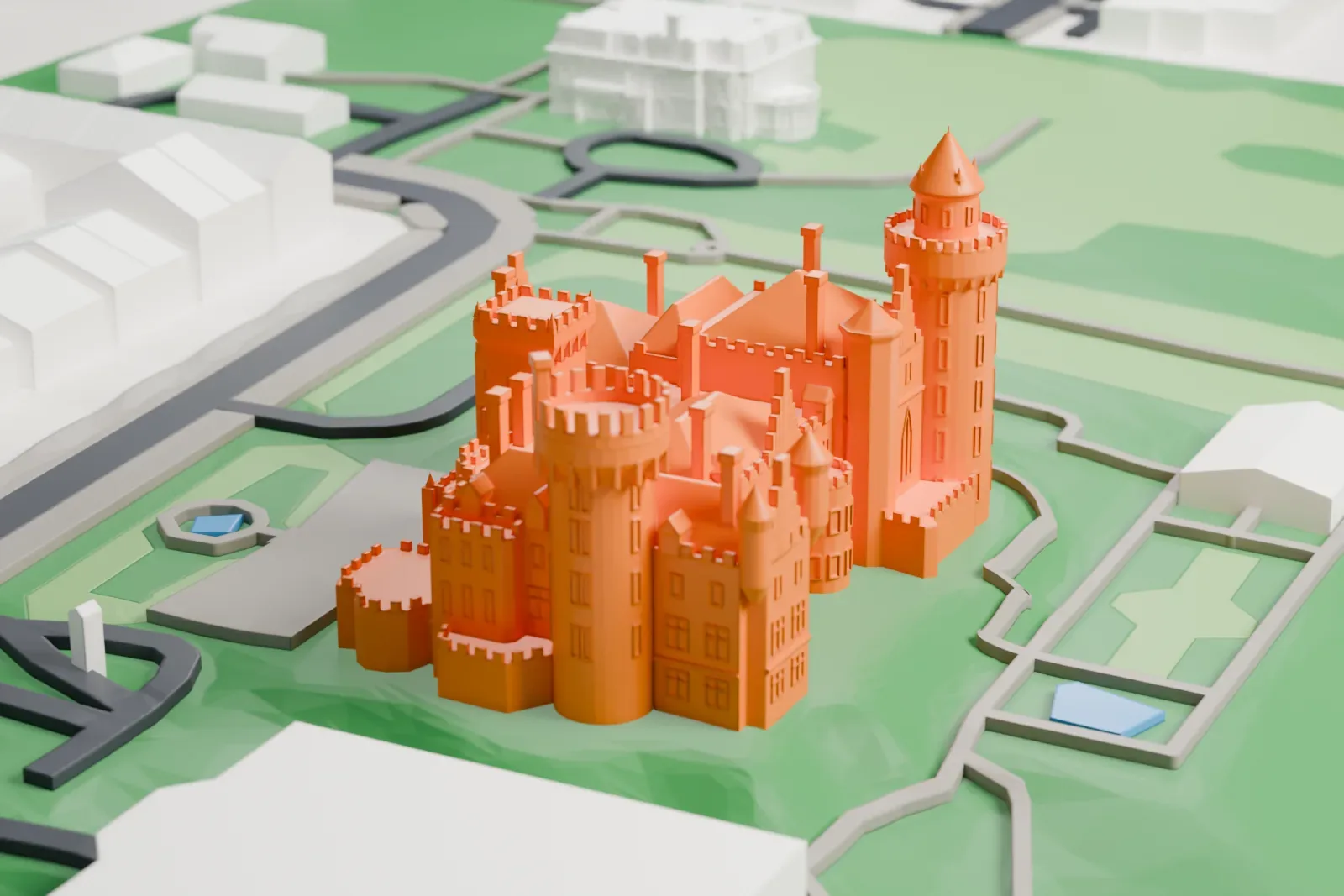 A white 3D print of Casa Loma, a castle-style mansion, among the surrounding streets and buildings.