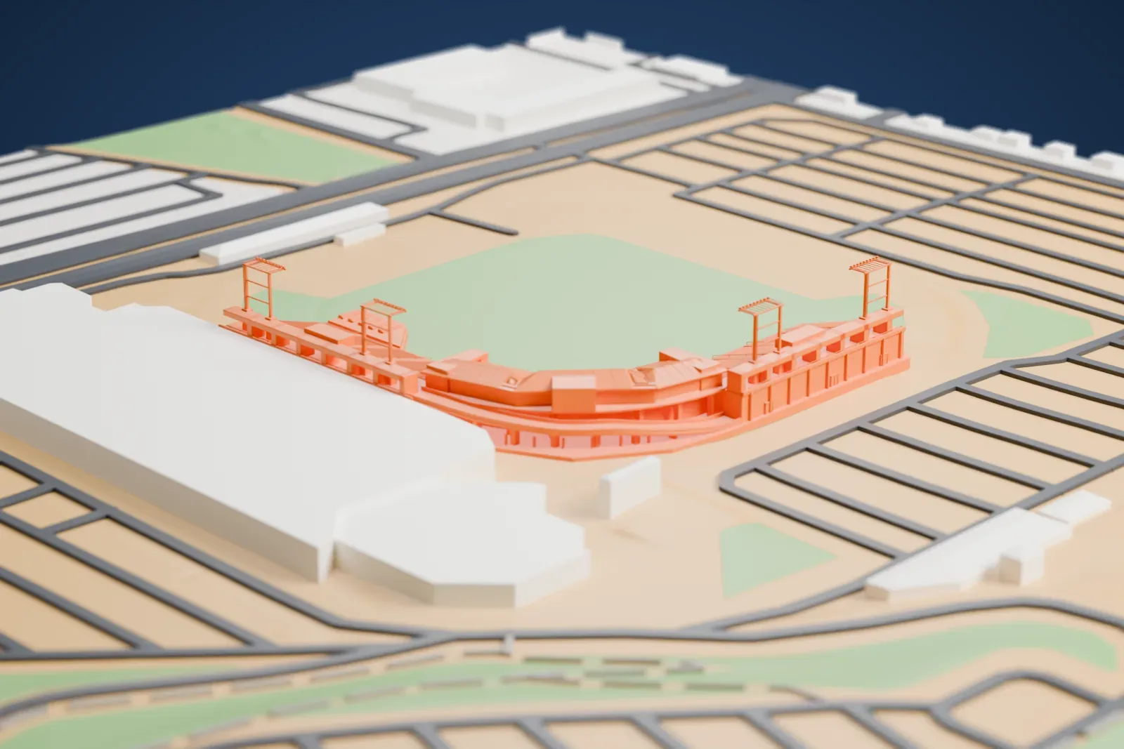A white 3D print of Cashman Field, a curved grandstand with slim light-tower frames around a grass field, beside a large building and a grid of roads.