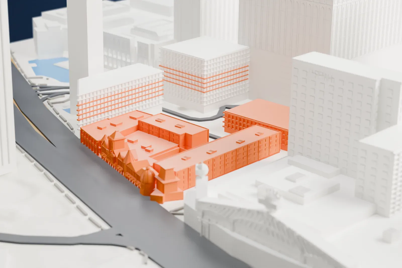 A white 3D print of the Casino Royale, a low complex with an ornate gabled corner facade beside a wide road, with taller buildings around it.