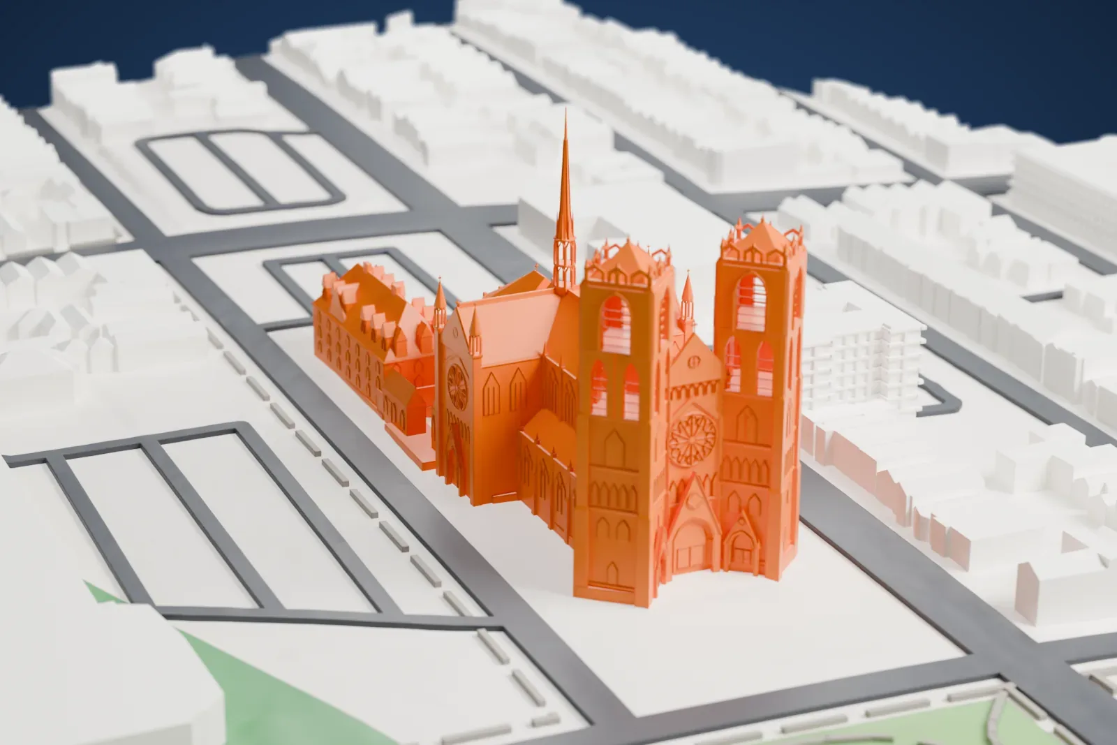 A white 3D print of the Cathedral Basilica of the Sacred Heart, with its twin towers and slender spire, among houses, streets and open green ground.