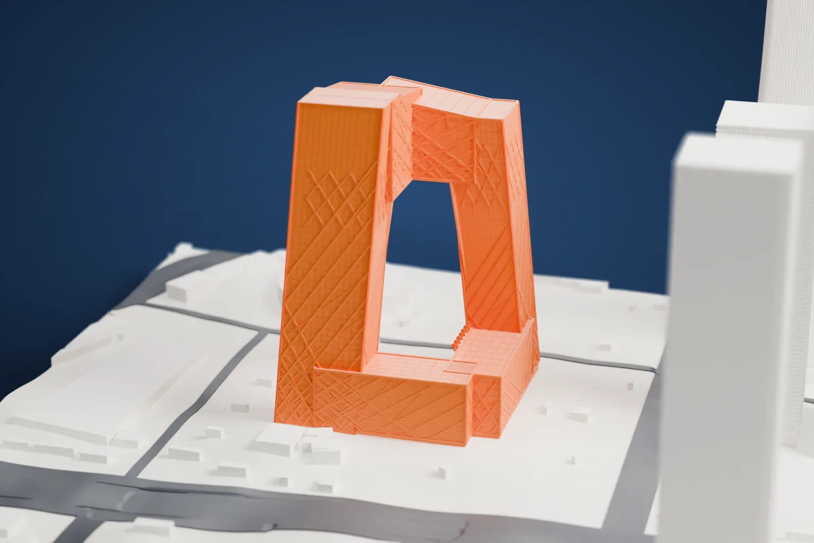 A white 3D print of the CCTV Headquarters, a loop of leaning angular sections covered in a diagonal grid around an open center, standing among roads and neighboring buildings.