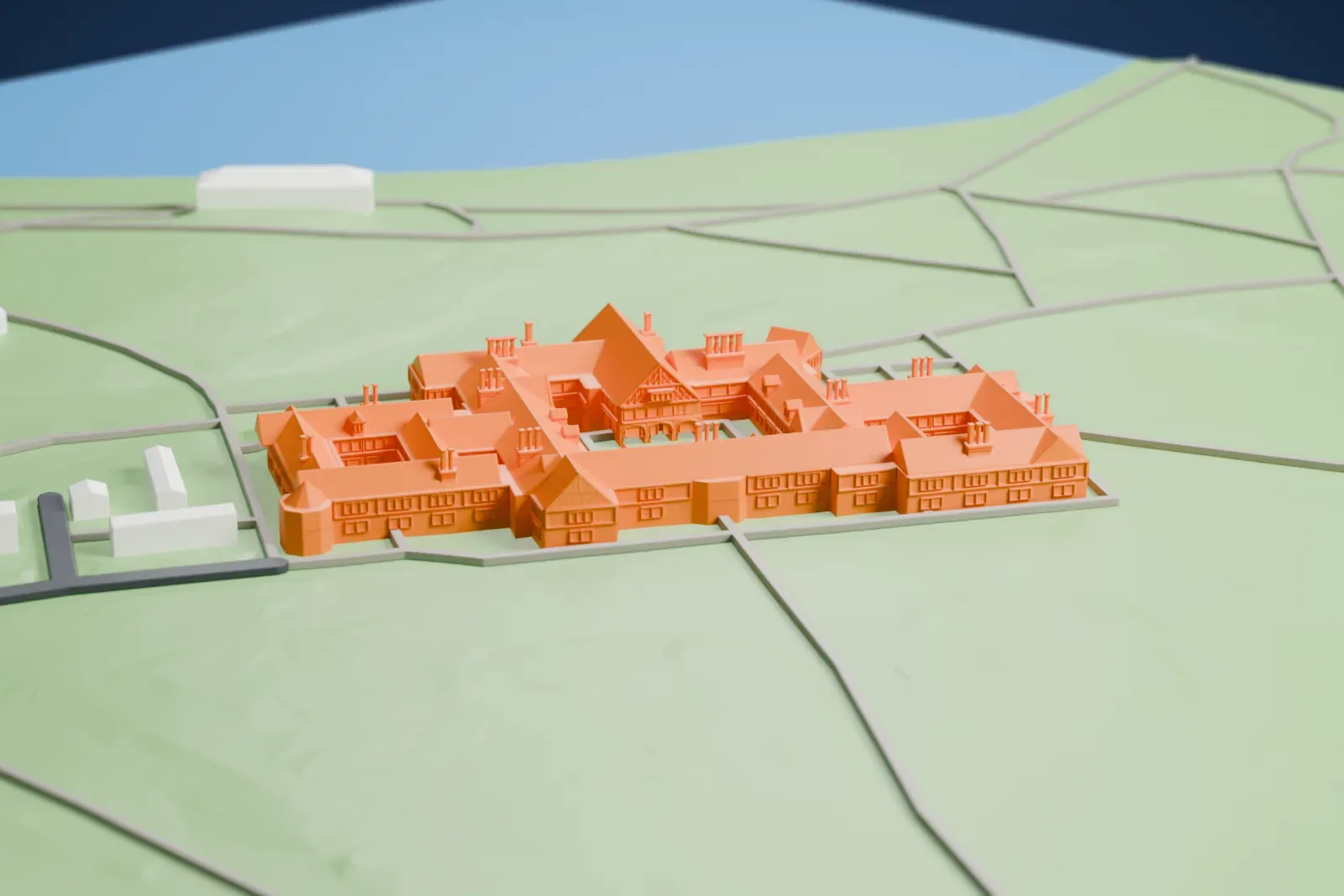 A white 3D print of Cecilienhof, a long, low palace, among the surrounding park and buildings of Potsdam.