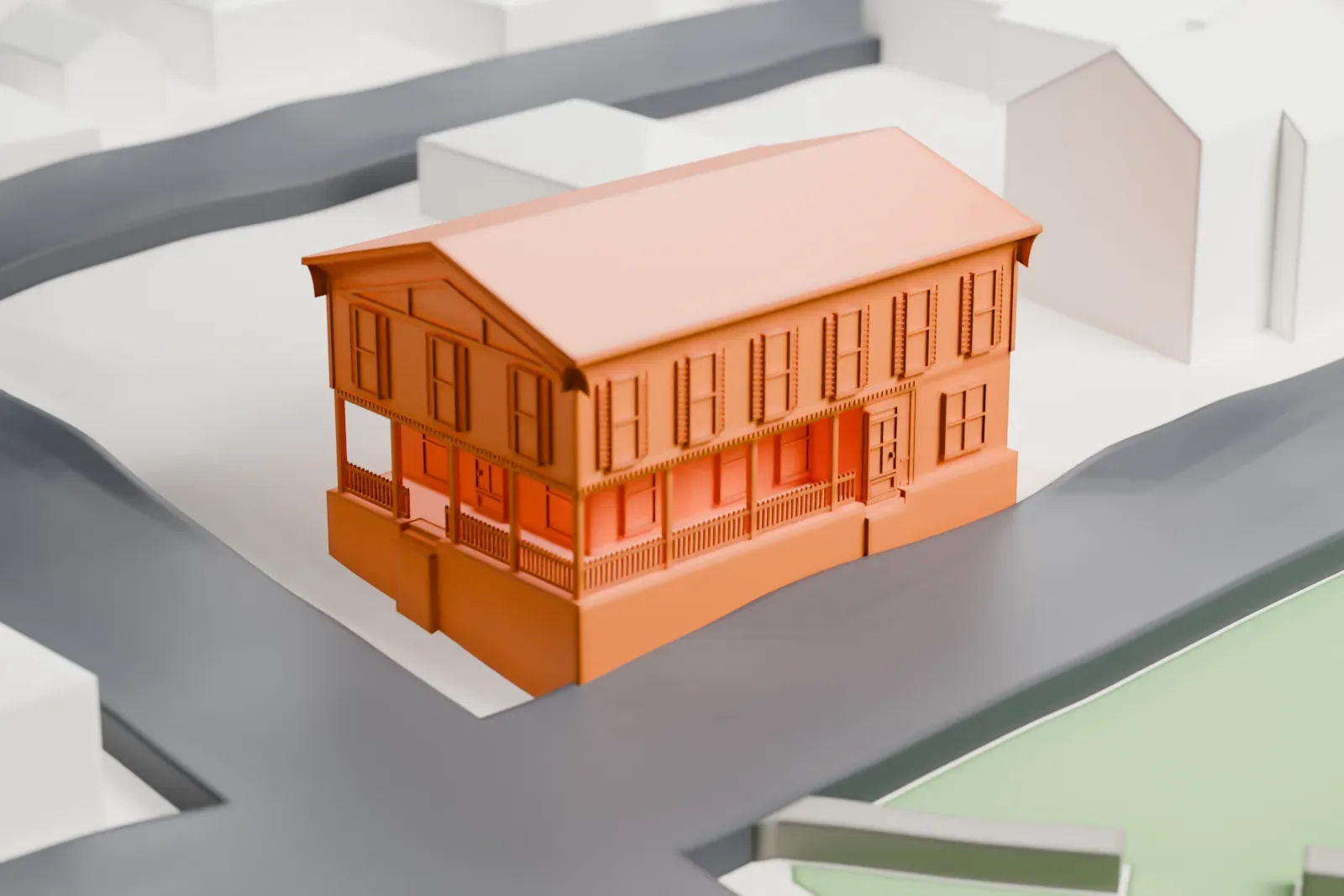 A white 3D print of Central Hall, a two-story building with a low gable roof, standing between streets with small houses nearby.