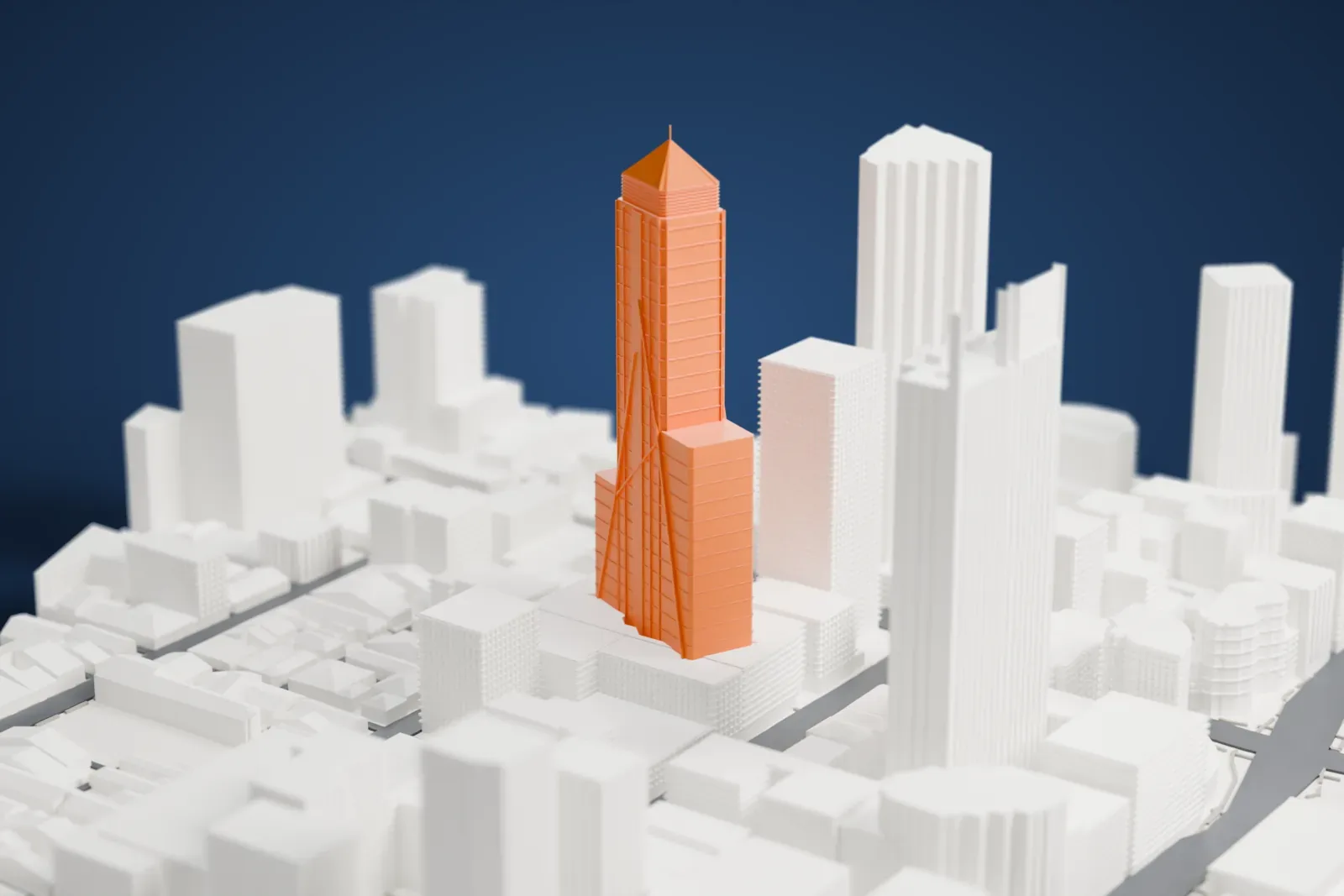 A white 3D print of the Central Park Tower with stepped sides and a pointed crown, surrounded by tall buildings, streets and a small green space.