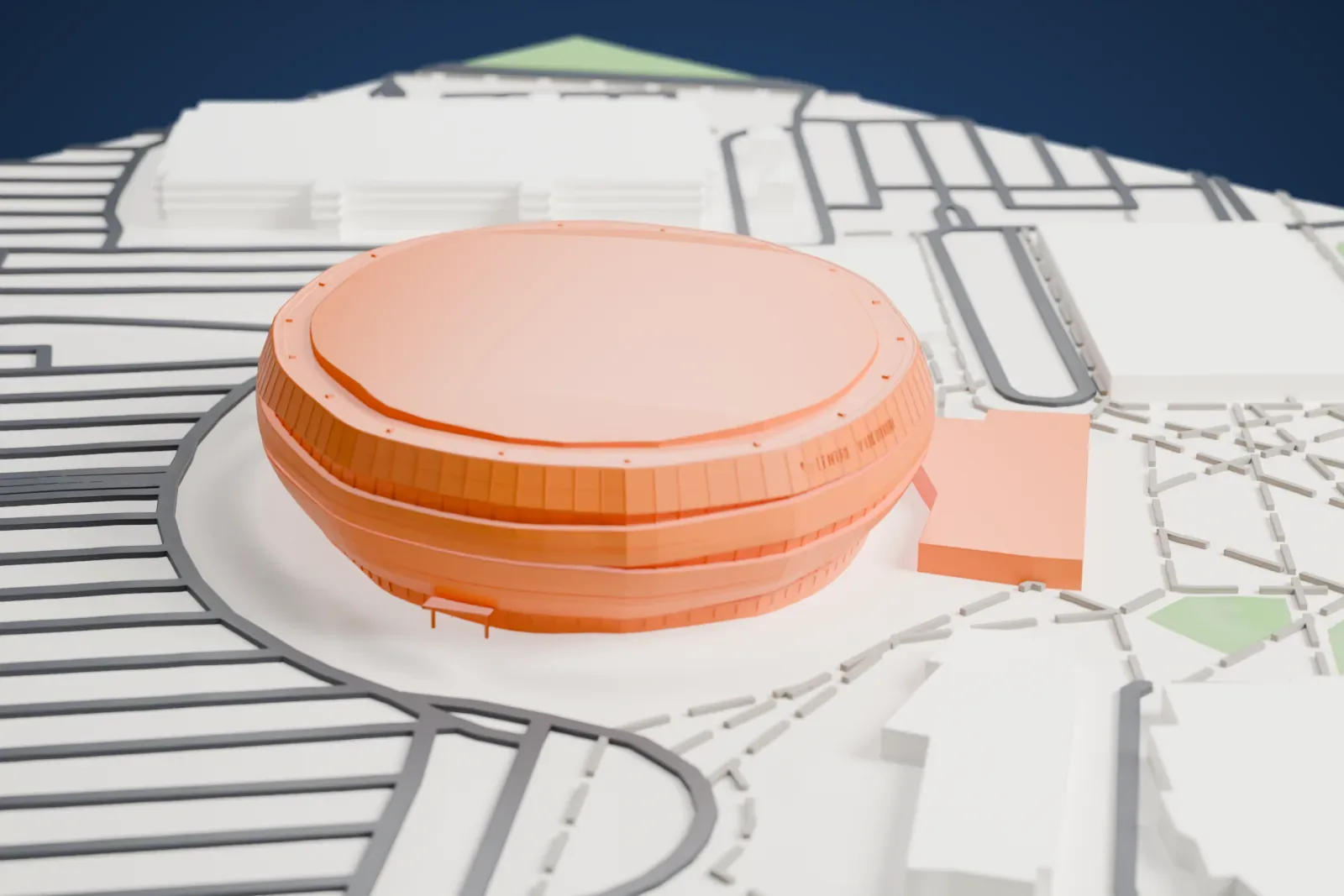 A white 3D print of Centre Vidéotron, a rounded, oval arena with banded walls and a broad flat roof, surrounded by streets, looping roads and low buildings.