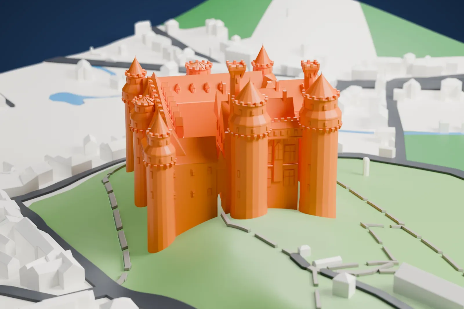 A white 3D print of the Château de Pierrefonds, a castle with round corner towers topped by cone-shaped roofs, standing on a grassy hill above village buildings.
