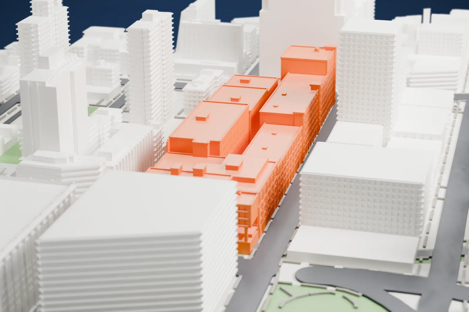 A white 3D print of Chelsea Market, a long chain of joined mid-rise buildings filling a city block, with taller buildings and a stretch of water beyond.