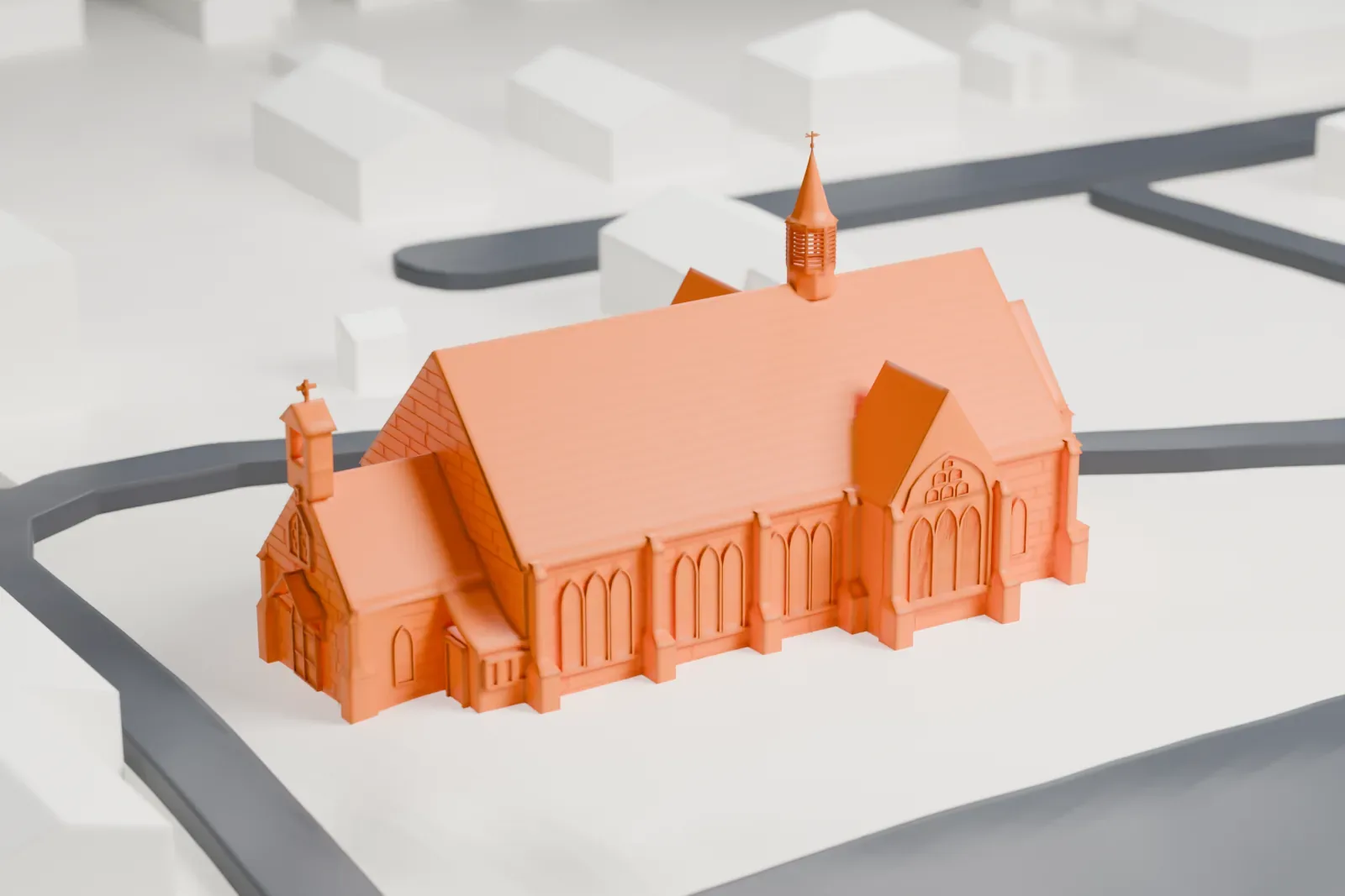 A white 3D print of Christ Church in Oyster Bay, a long church with a steep ribbed roof, a slim spire and arched windows, set on open grounds beside curving roads.