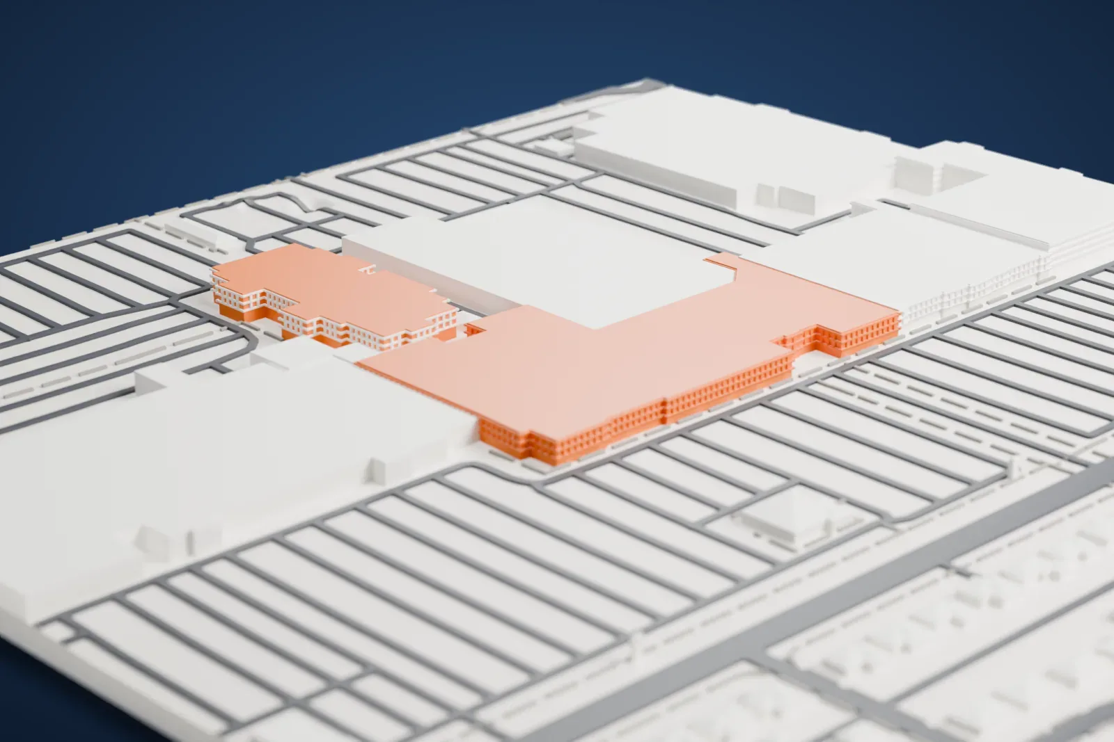 A white 3D print of Christown Spectrum Mall, a long, low building with a flat roof, set among parking lots and neighborhood streets.