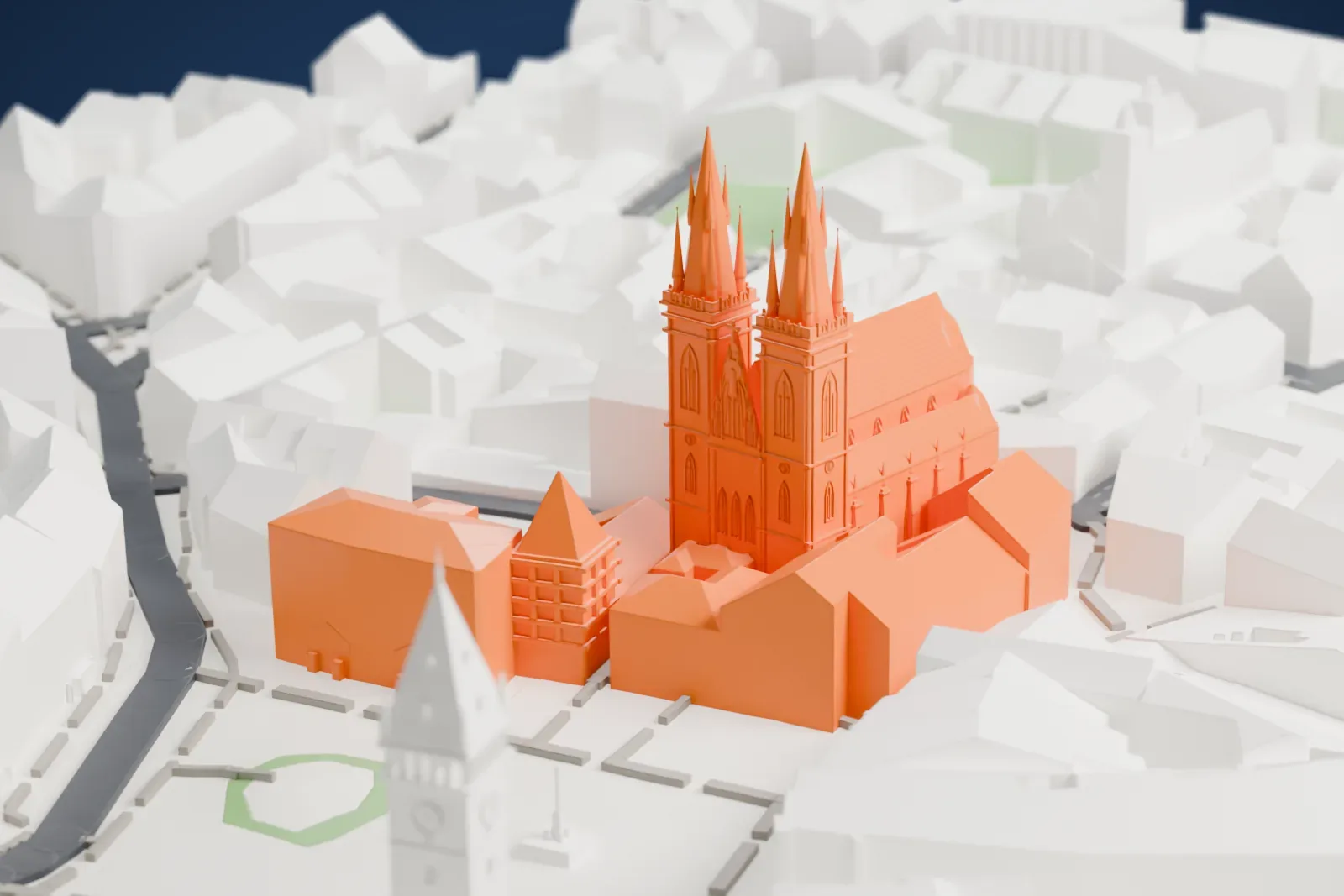 A white 3D print of the Church of Our Lady before Týn, a long steep-roofed church with two tall spired towers, surrounded by tightly packed buildings and an open square.